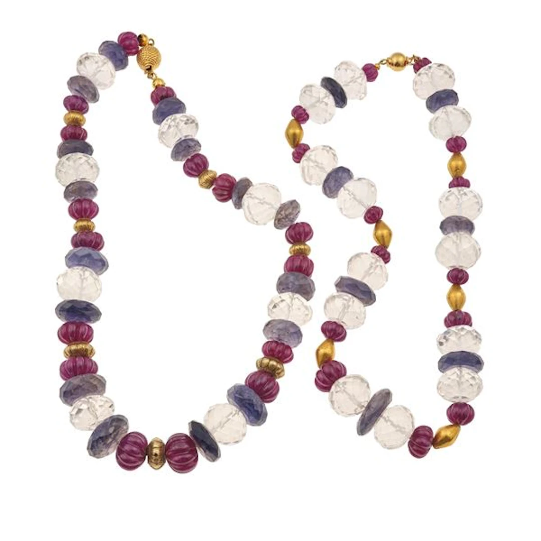 Two rock crystal, carved ruby, iolite and gold necklaces