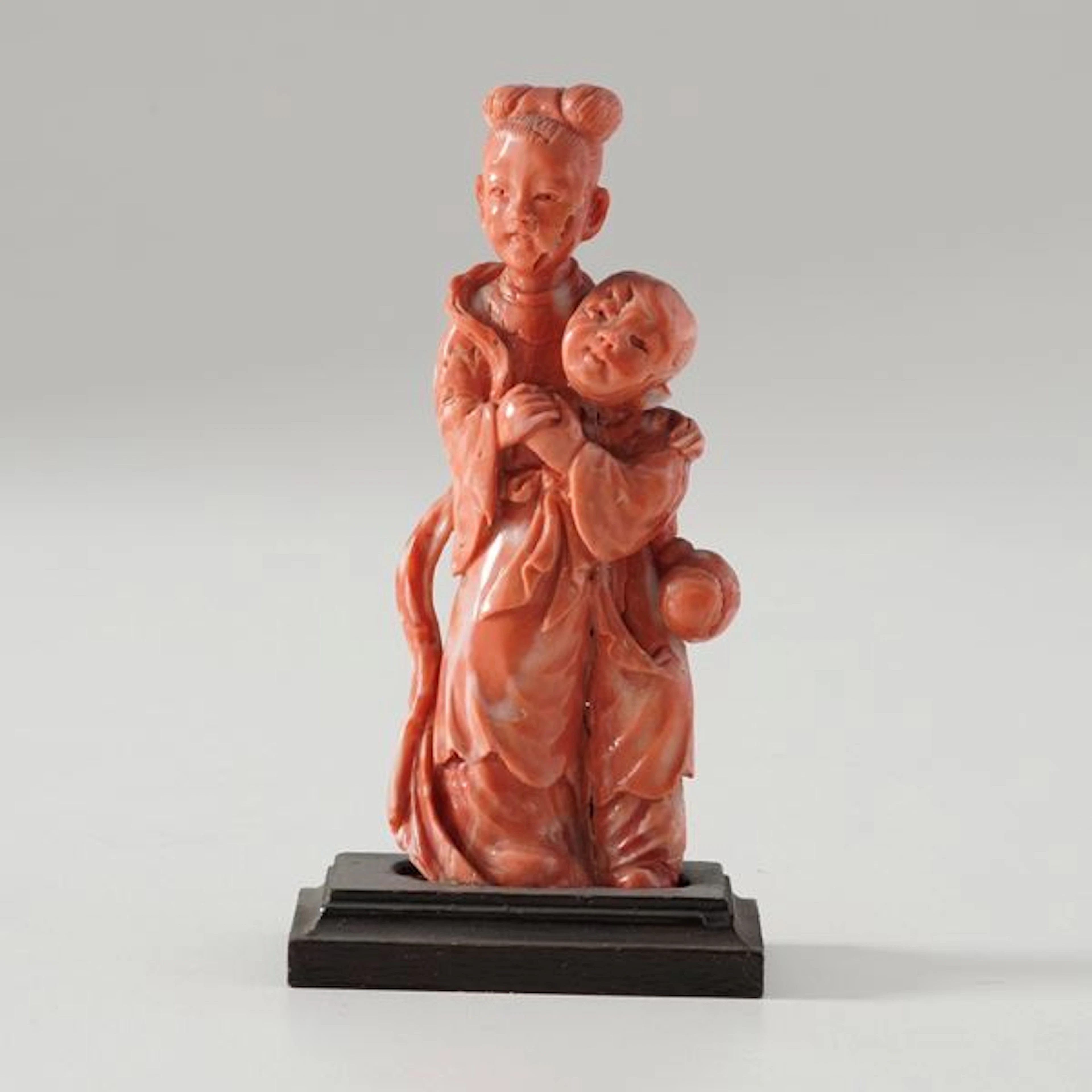 Small coral figure of a woman with a child
