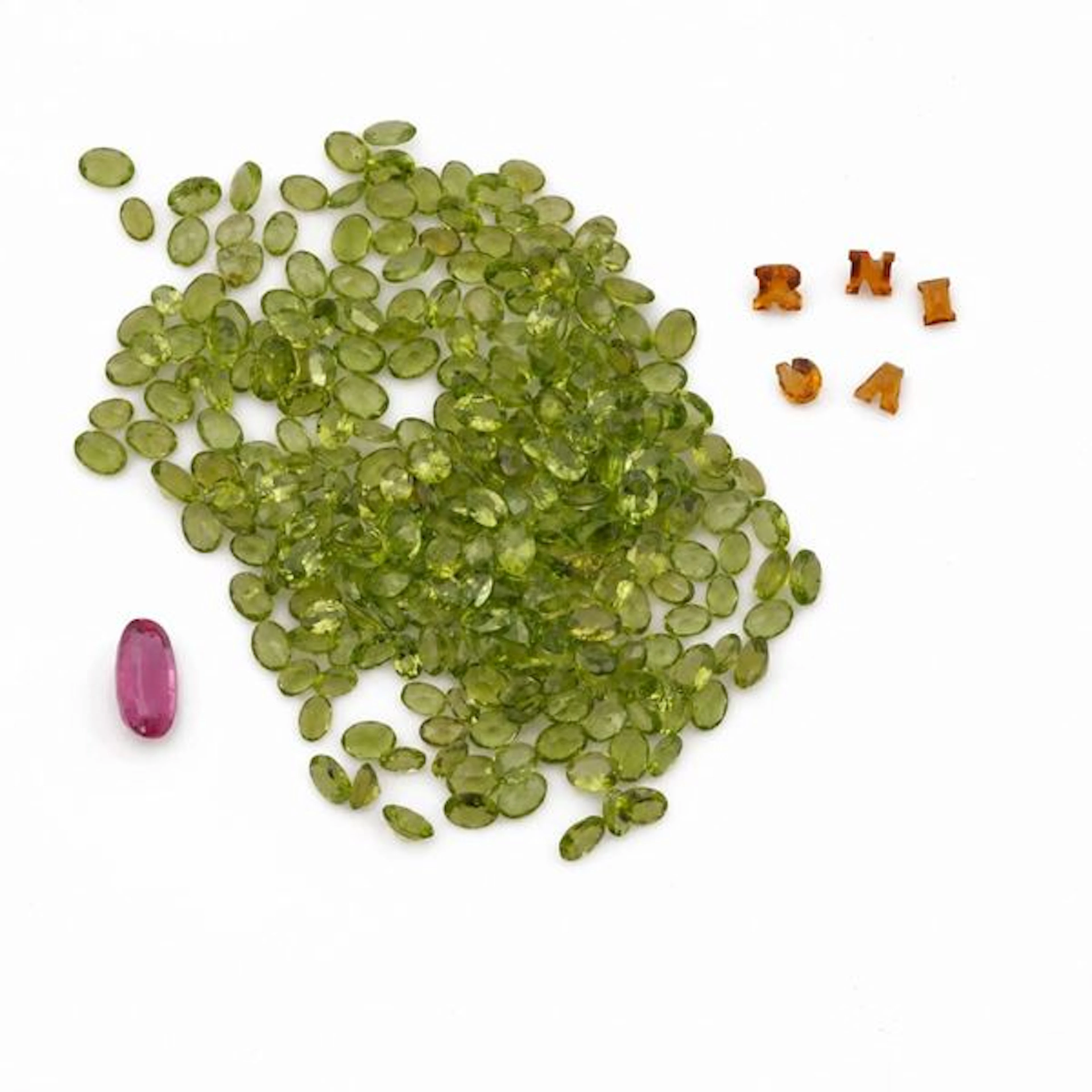 Collection of unmounted gemstones, including amethysts, peridots and