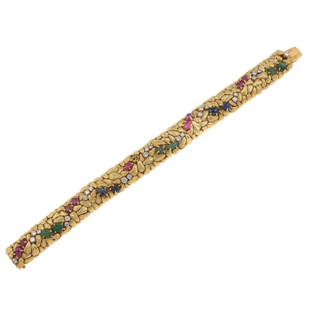 Carvedgemstones, diamond and gold bracelet. One missing ruby