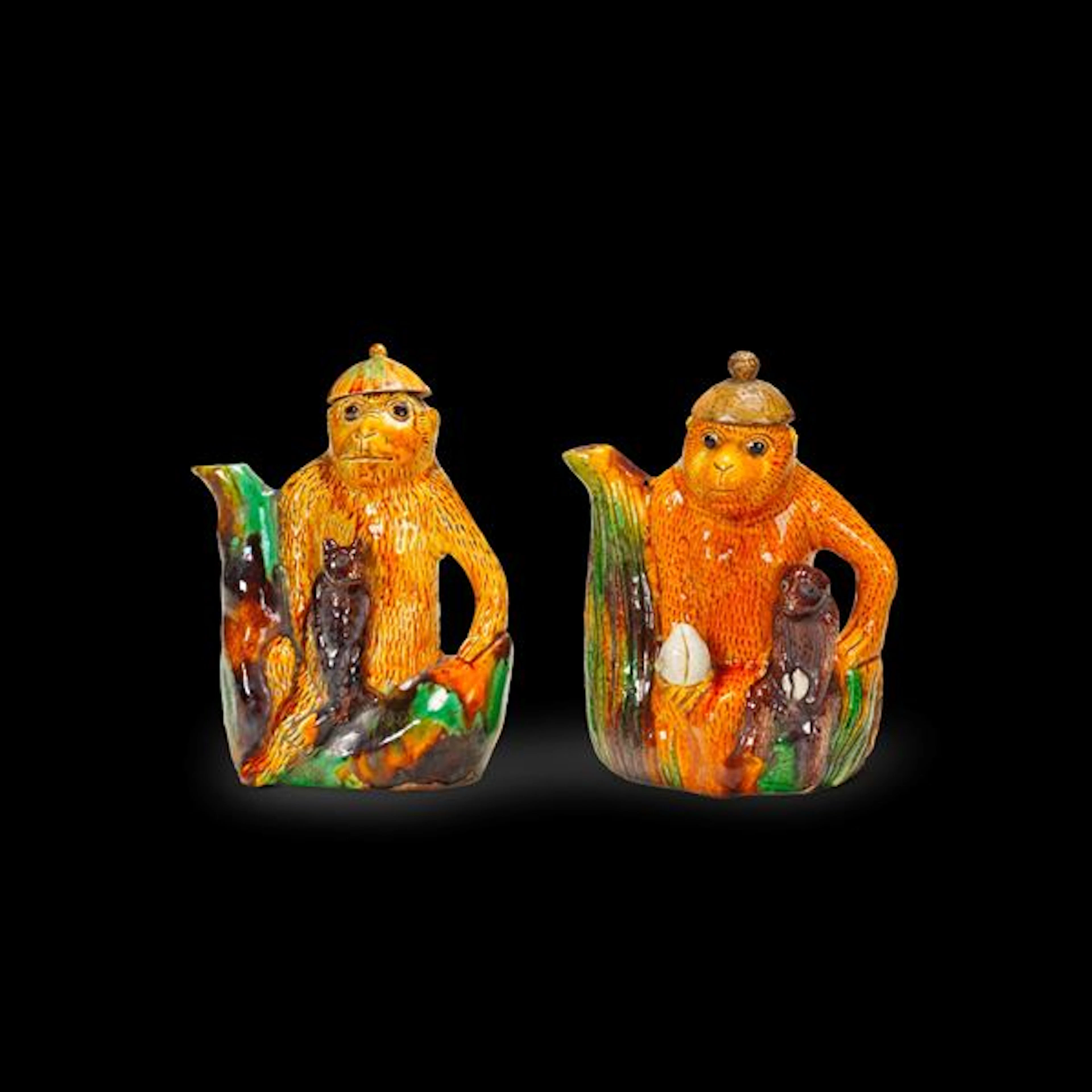 Pair of Sancai porcelain teapots depicting little monkeys, China