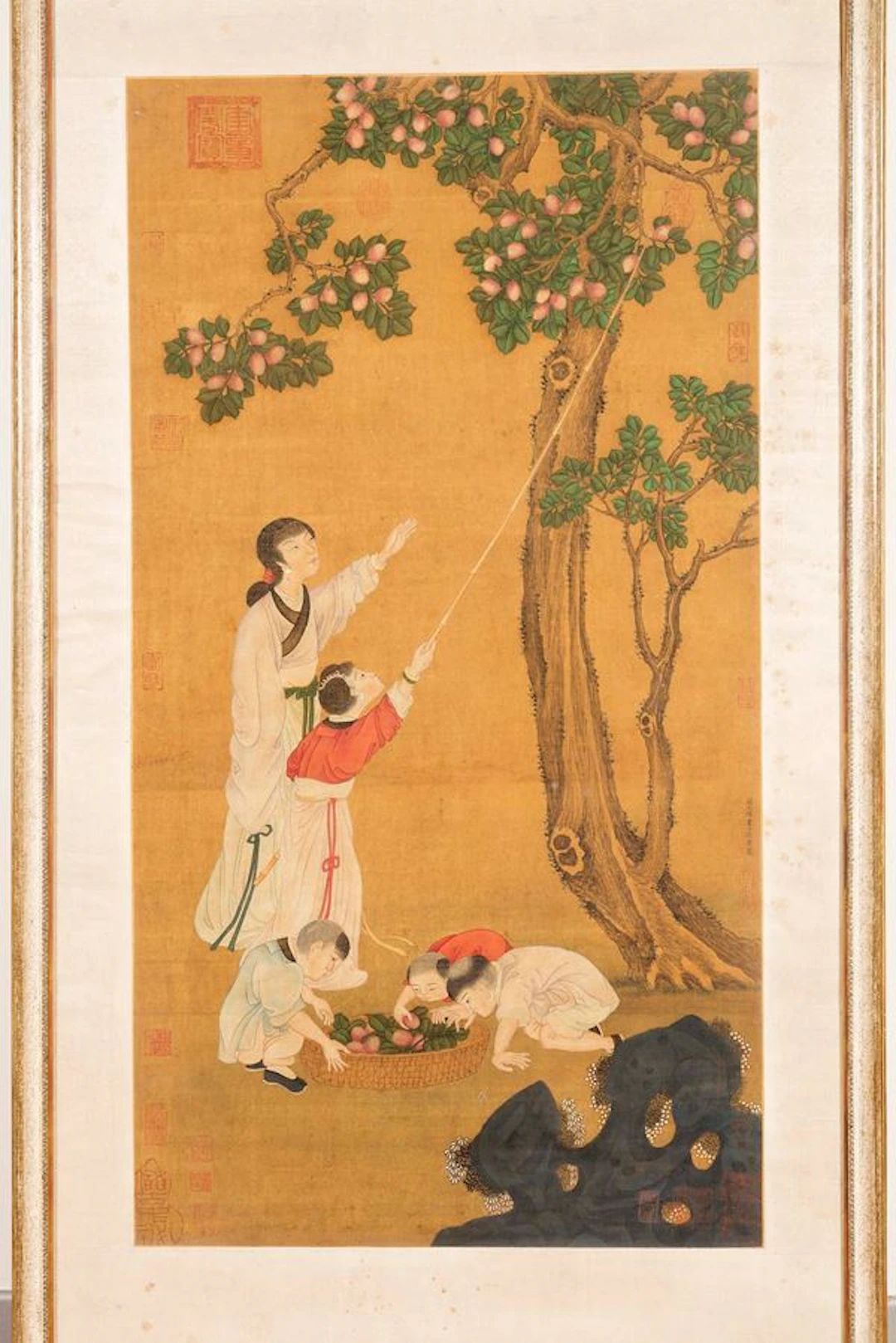 A painting on silk depicting Guanyin with child picking peaches, China