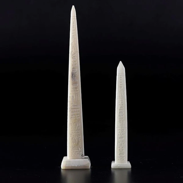 2 obelisks carved from white marble