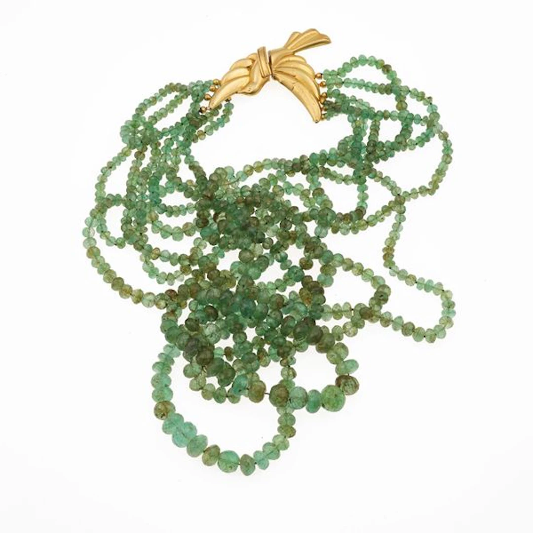 Six strand of emerald and gold necklace. Damage