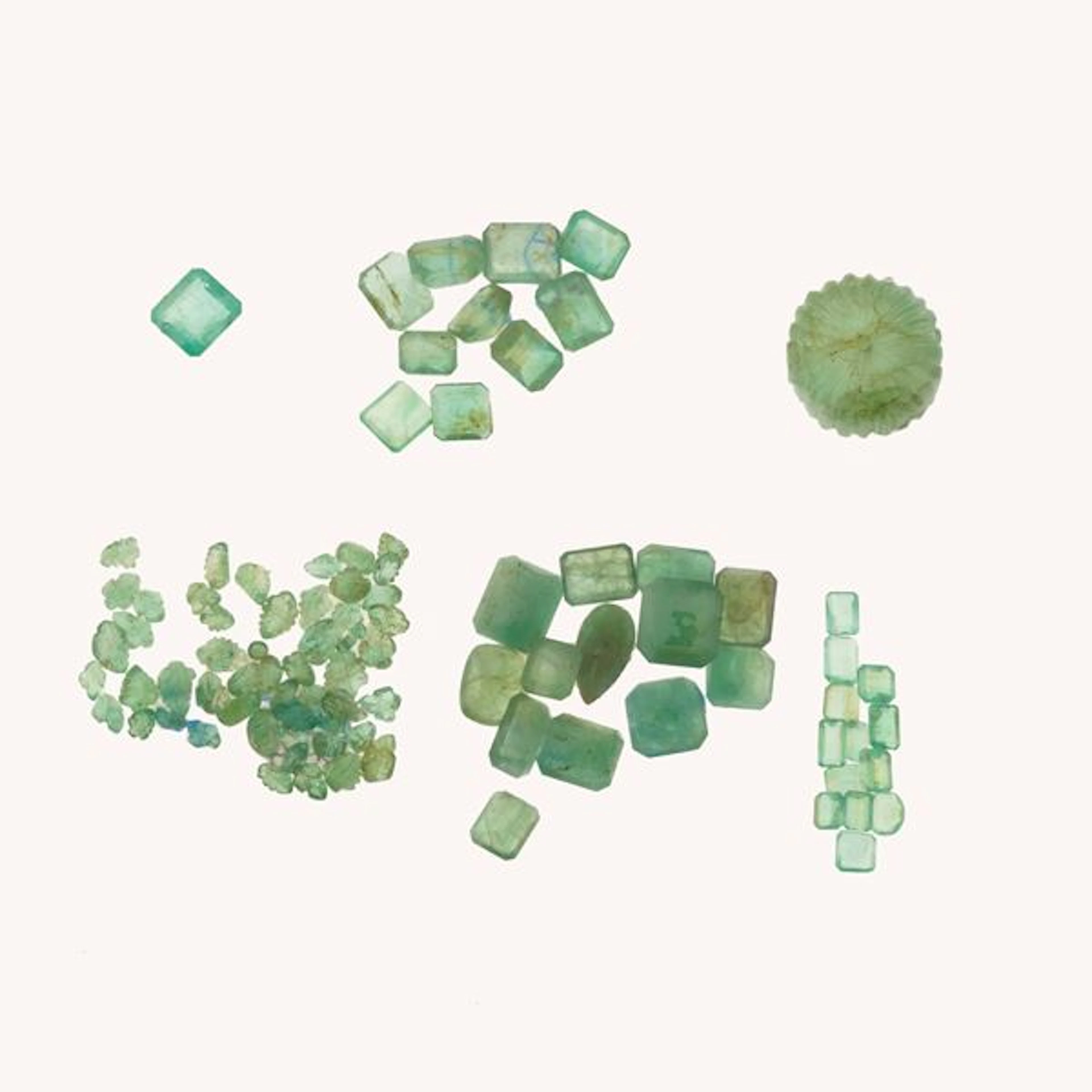 Collection of unmounted emeralds, of various shapes and treatments