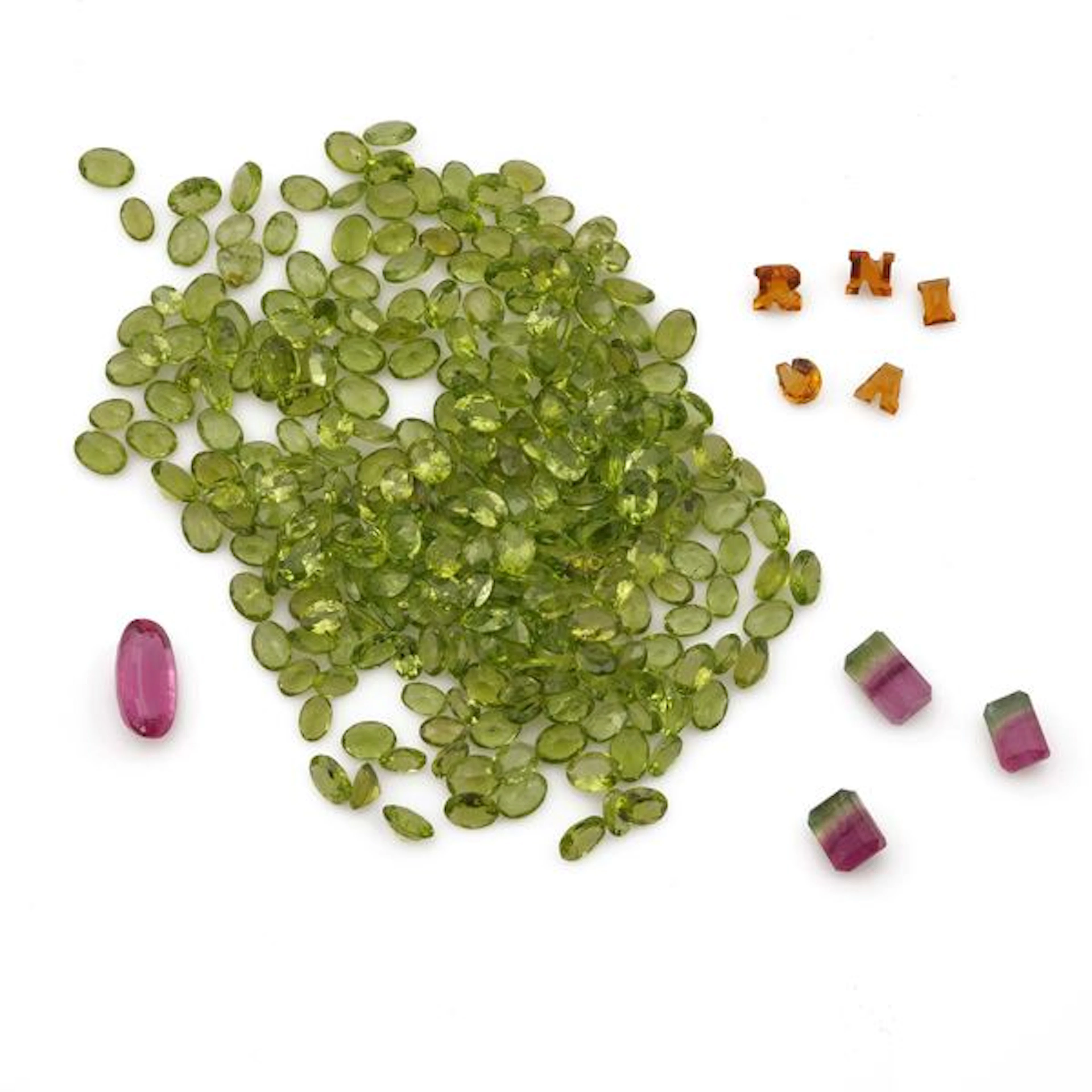 Collection of unmounted gemstones, including amethysts, peridots and