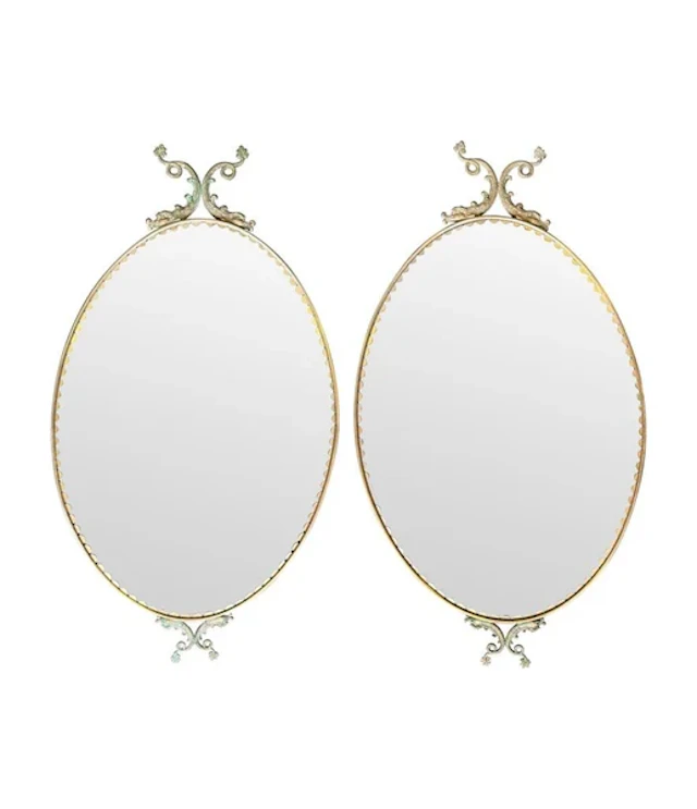 A pair of Italian 1940s oval mirrors with dolphin detailing around