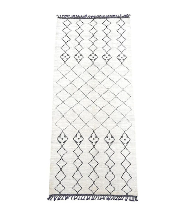 A large handwoven Moroccan Beni Ourain wool berber rug with tribal