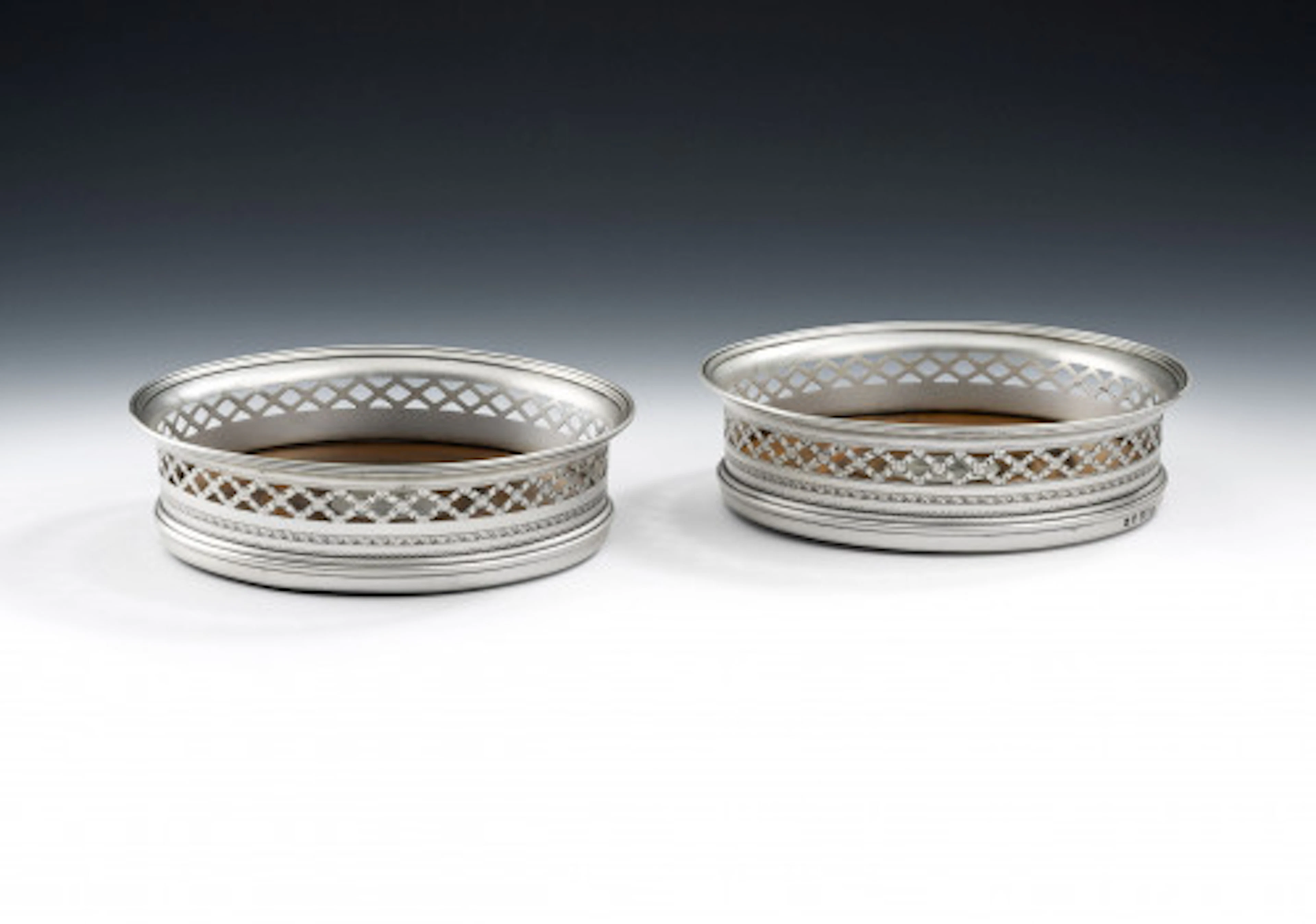 A very unusual pair of George III "tRELLIS wORK" wINE cOASTERS MADE