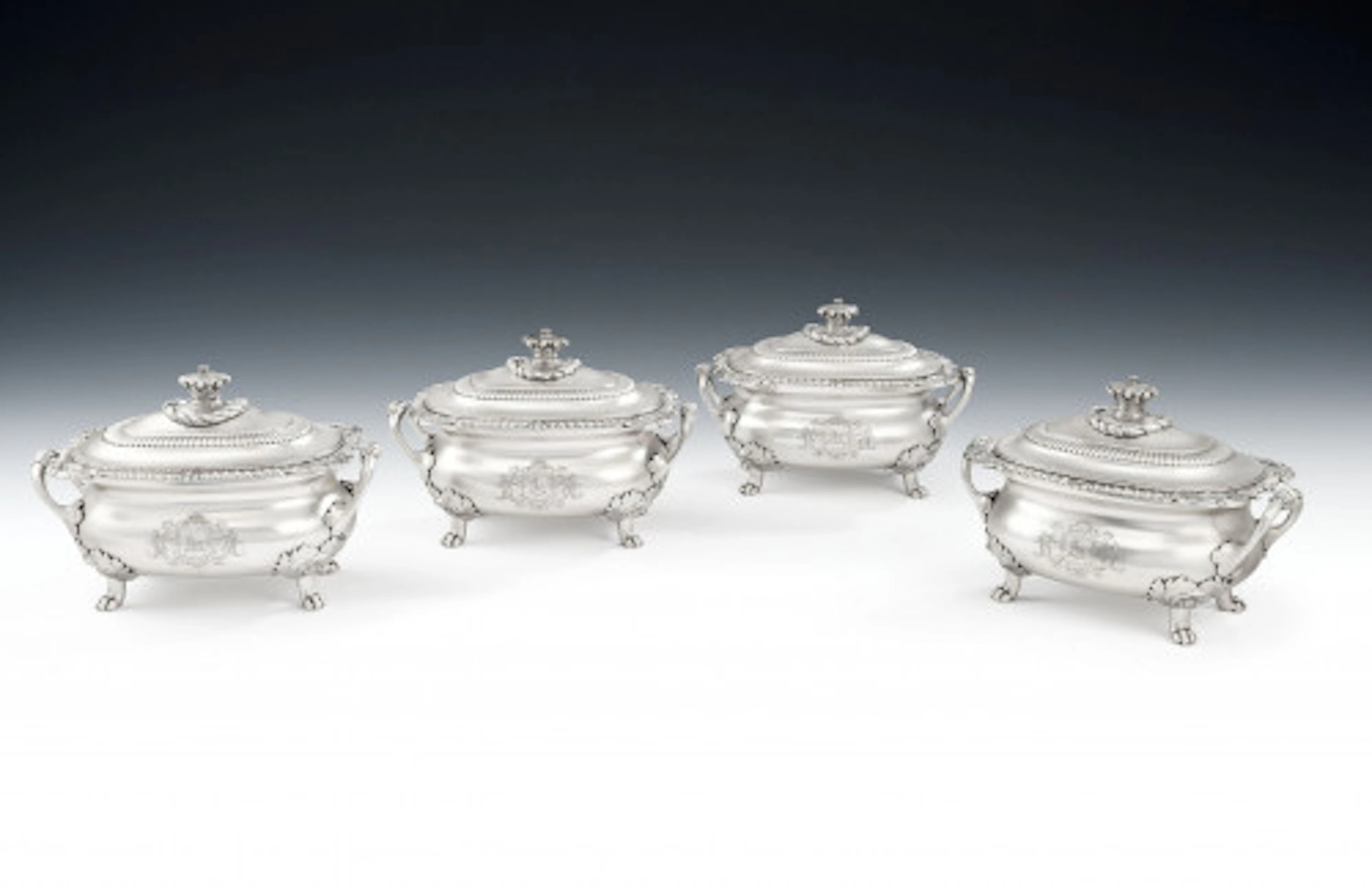 An exceptional set of four George III Heraldic Sauce Tureens made