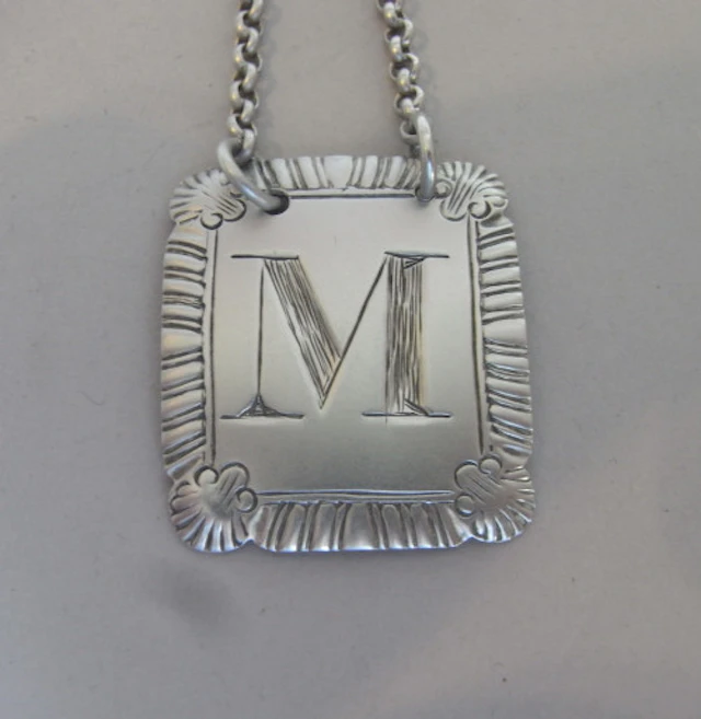 An unusual letter "M" Wine Label made in London in 1815 by John Reilly.