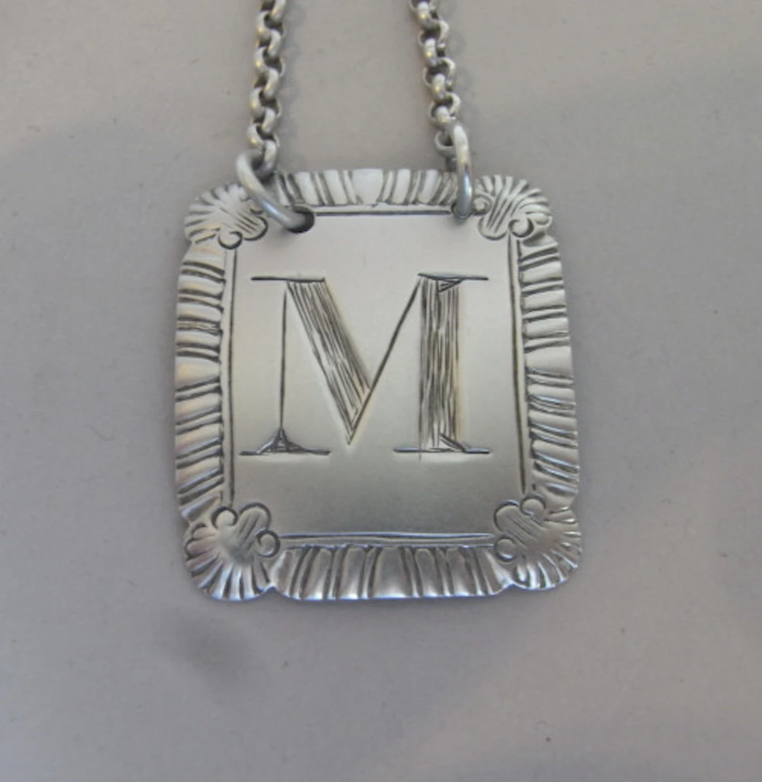 An unusual letter "M" Wine Label made in London in 1815 by John Reilly.