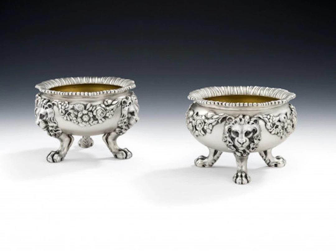 PAUL STORR. An outstanding pair of William IV Lion Mask Salt Cellars