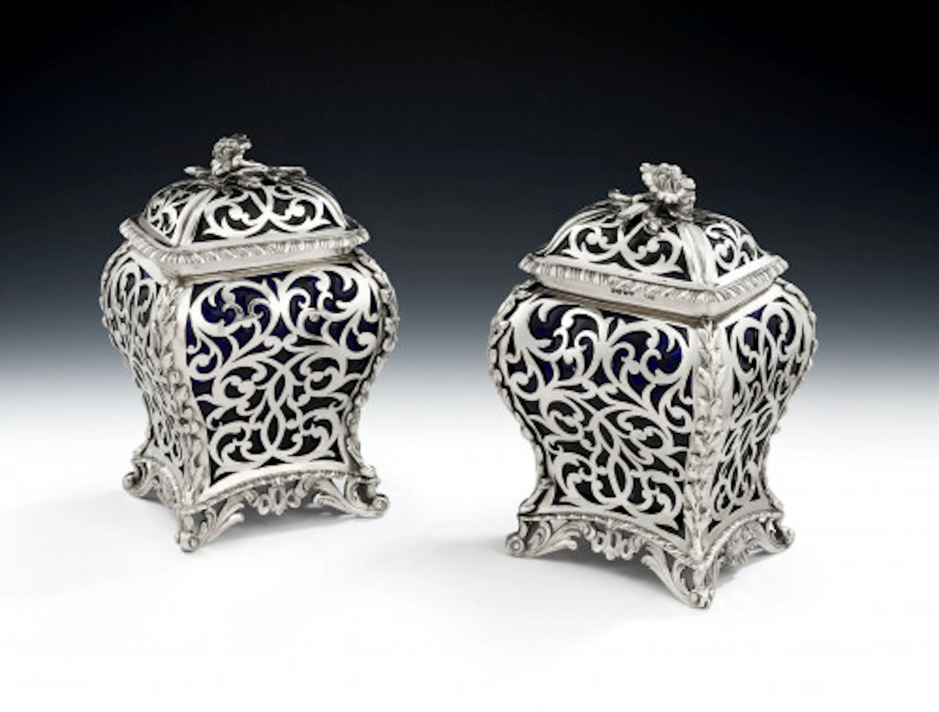 An extremely rare pair of Glass and silver Cagework Tea Caddies made