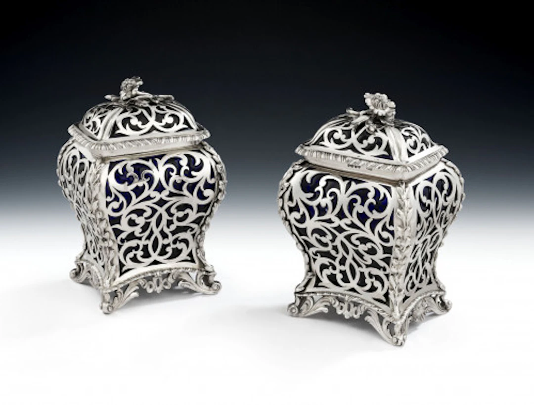 An extremely rare pair of Glass and silver Cagework Tea Caddies made
