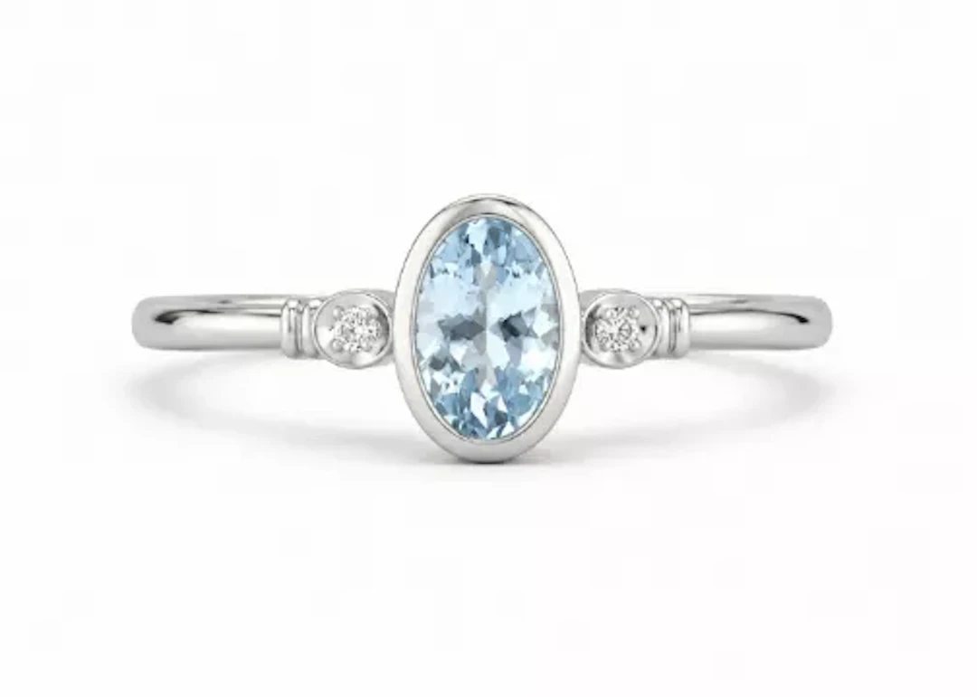 9ct White Gold Diamond And Oval Shape Blue Topaz Ring
