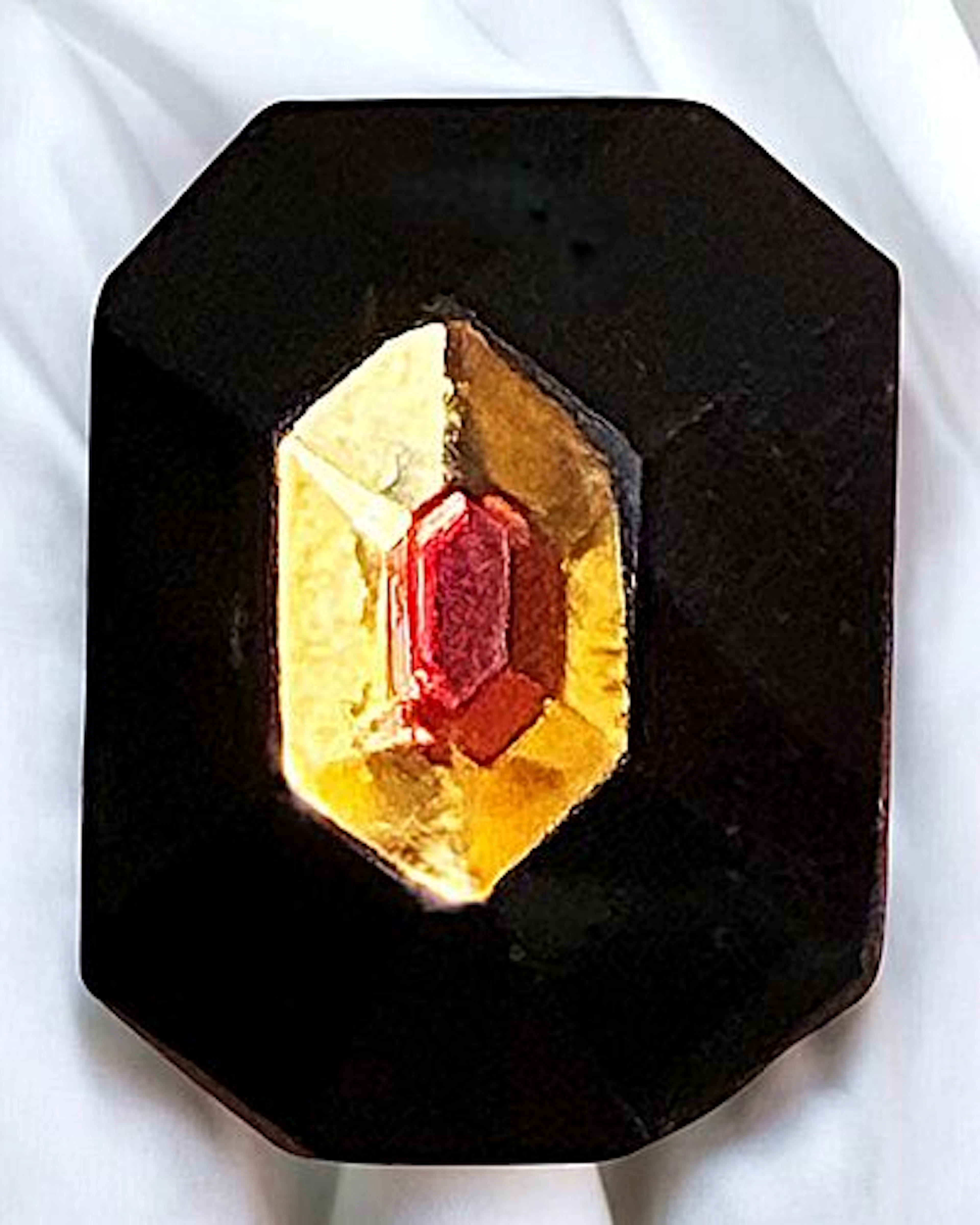 A DIVISION ONE CHARMSTRING GLASS BUTTON
