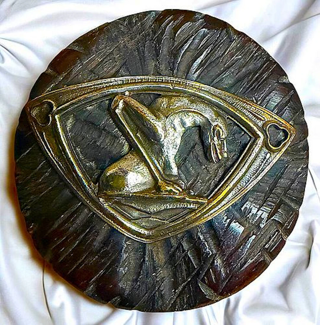 A DIVISION ONE BRASS ESCUTCHEONED WOOD BUTTON