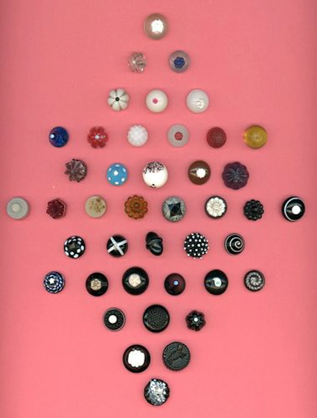 A CARD OF DIVISION ONE ASSORTED COLORED GLASS BUTTONS