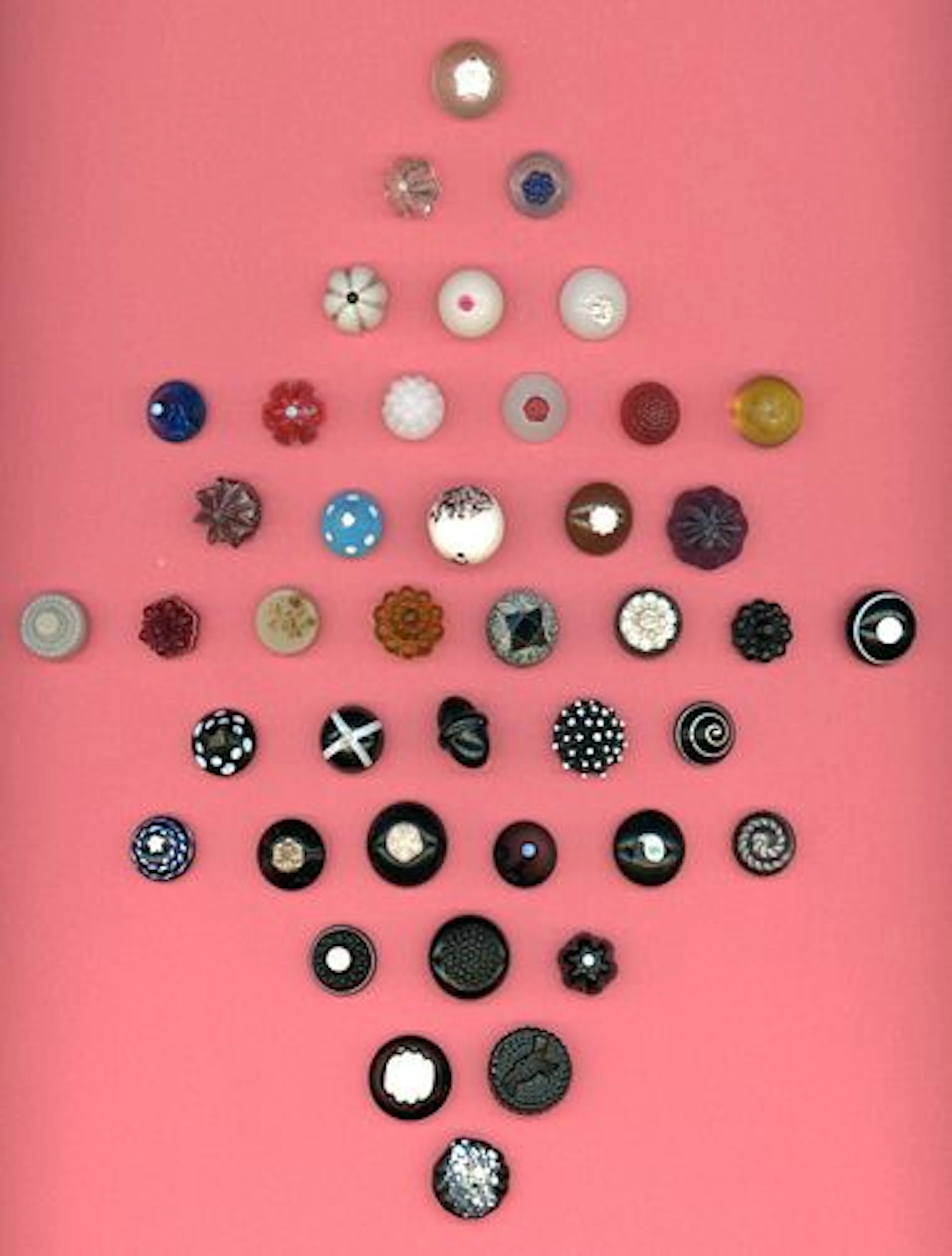 A CARD OF DIVISION ONE ASSORTED COLORED GLASS BUTTONS