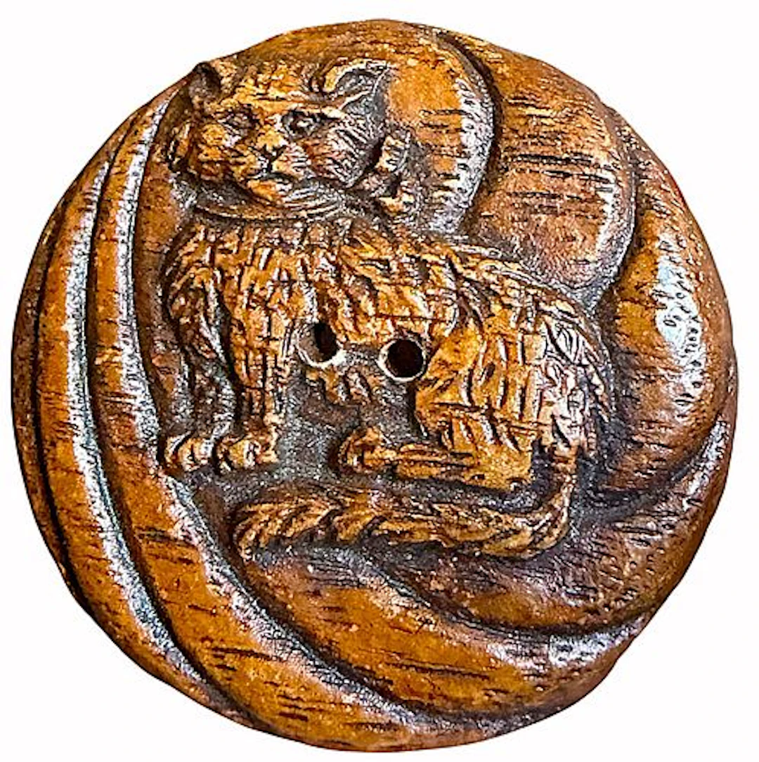 A SCARCE DIVISION THREE WOOD ANIMAL BUTTON