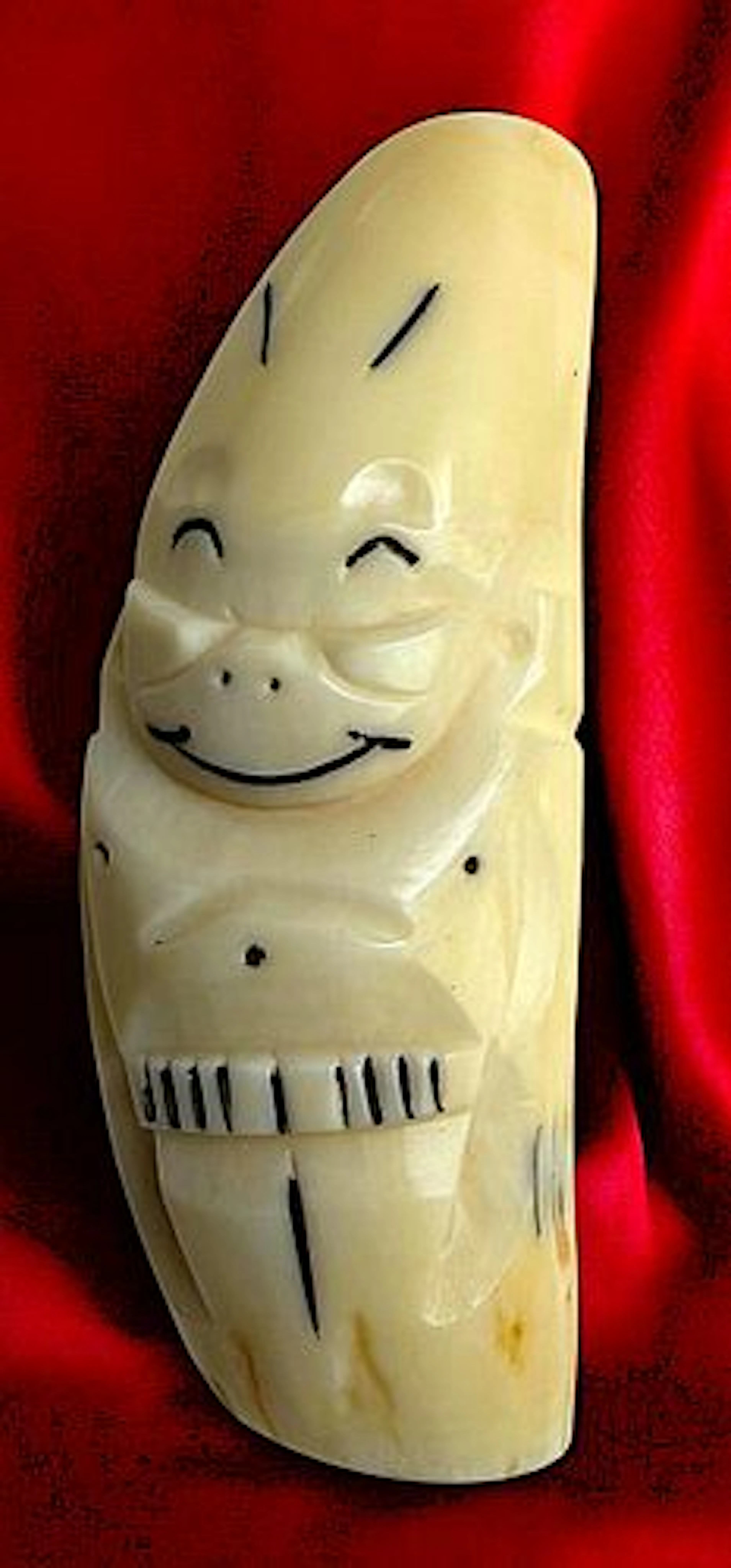 A DIVISION THREE CARVED BILLIKEN