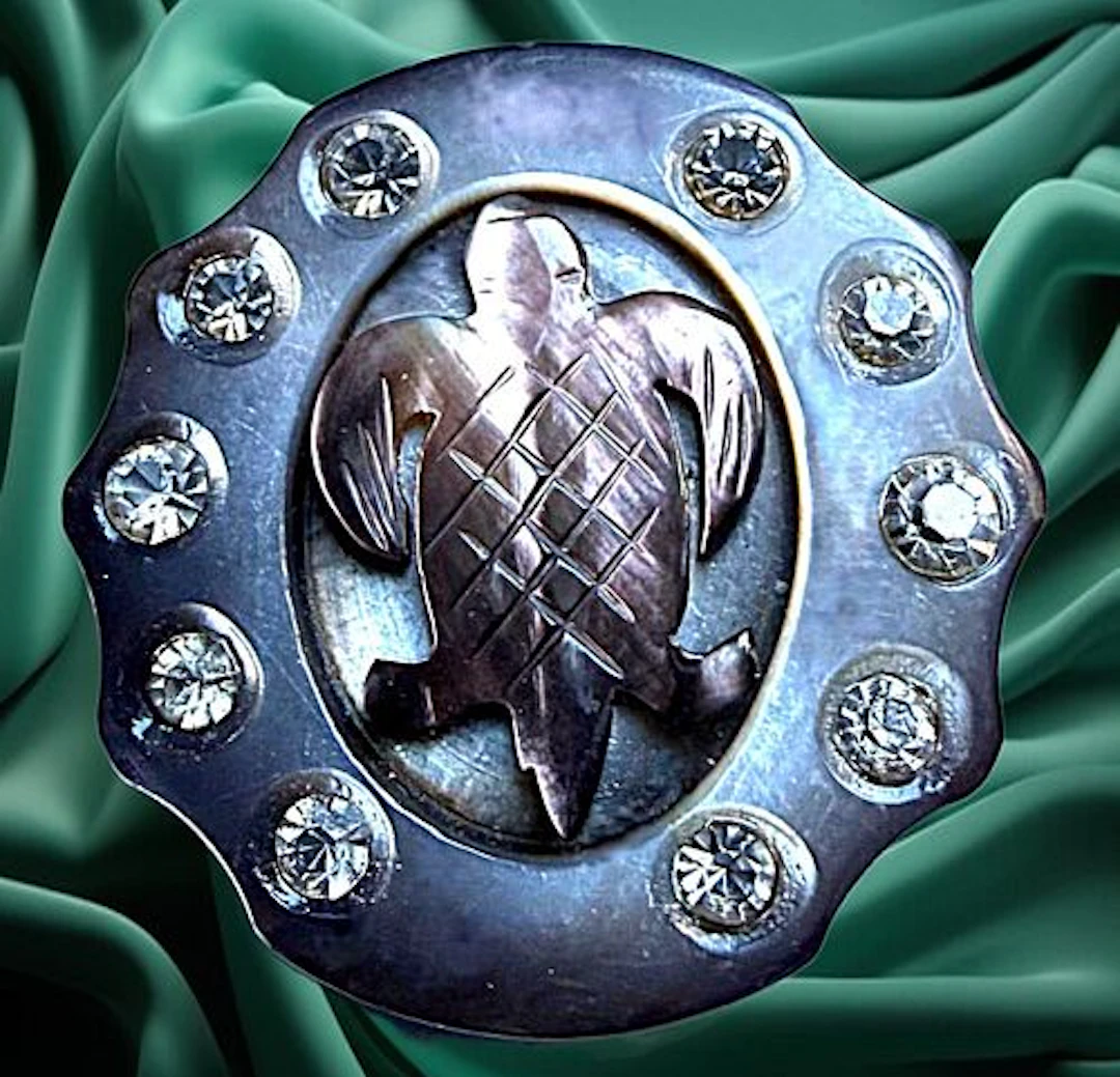 A DIVISION ONE CARVED PEARL AND PASTE ANIMAL BUTTON