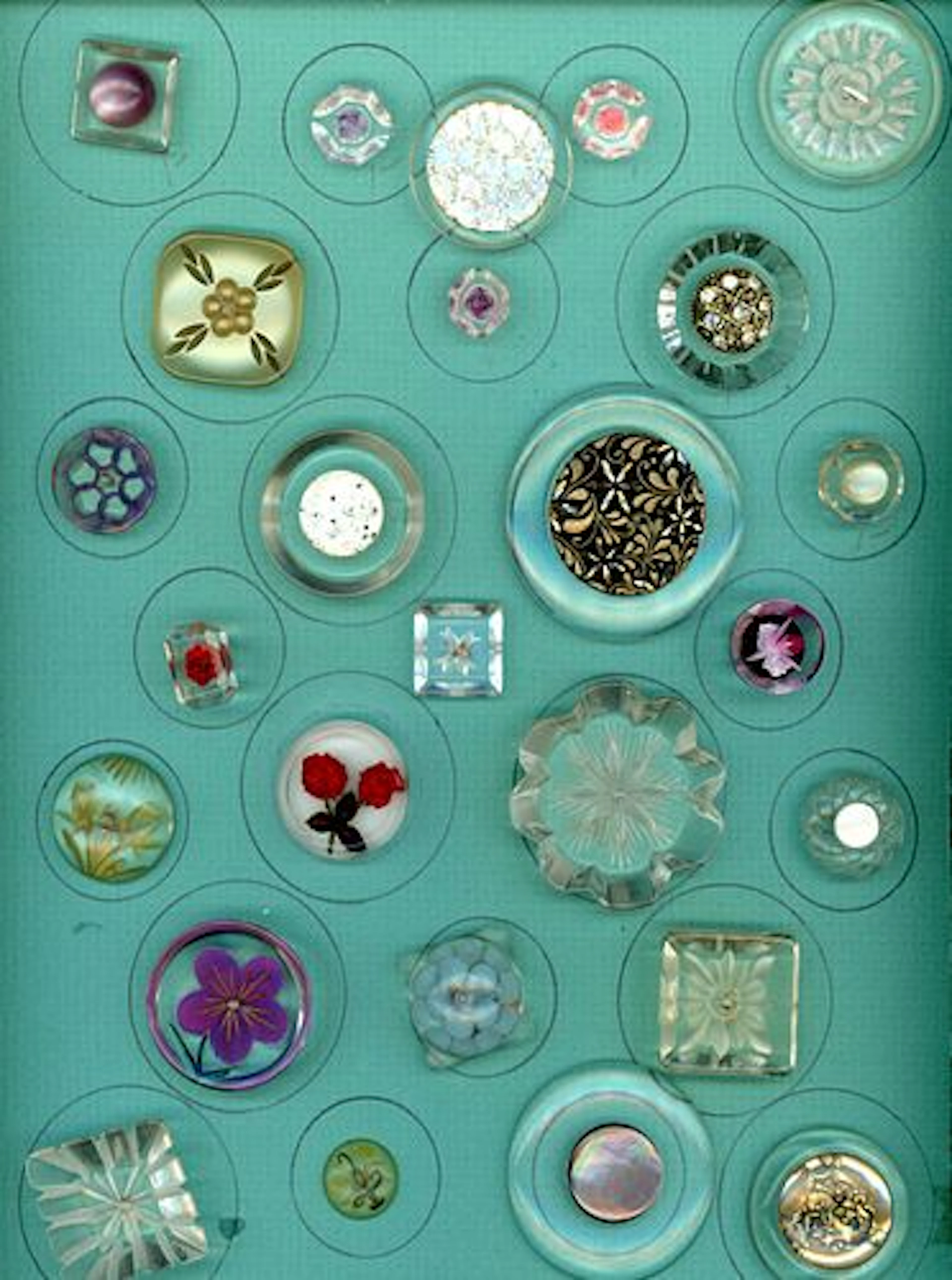 A CARD OF DIVISION THREE COLORFUL LUCITE BUTTONS