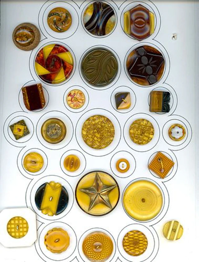 A CARD OF DIVISION THREE BAKELITE BUTTONS