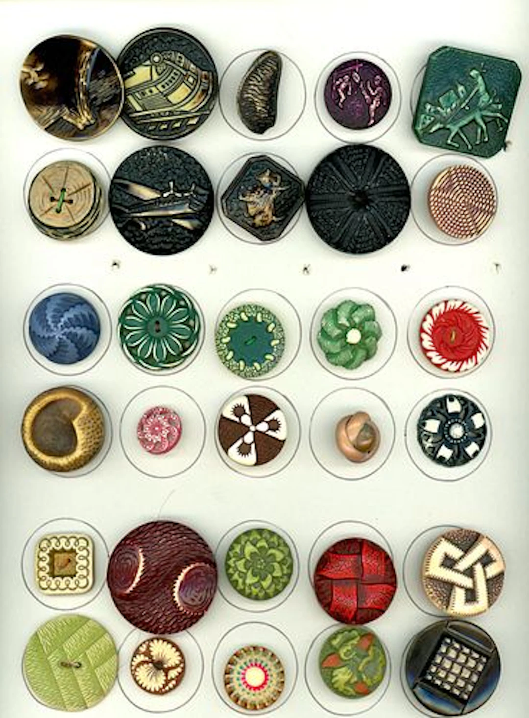 A CARD OF DIVISION THREE ASSORTED CELLULOID BUTTONS