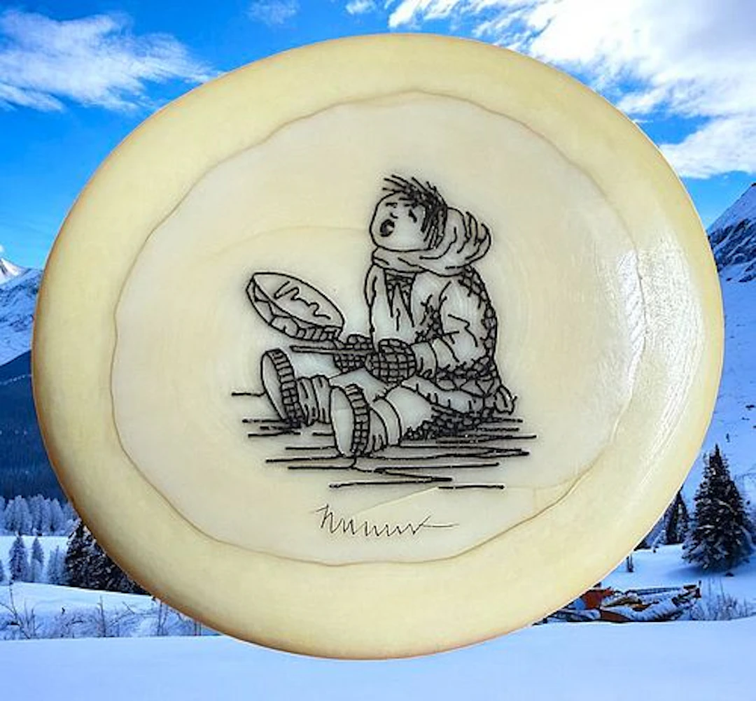 A DIVISION THREE ENGRAVED ESKIMO PICTORIAL BUTTON