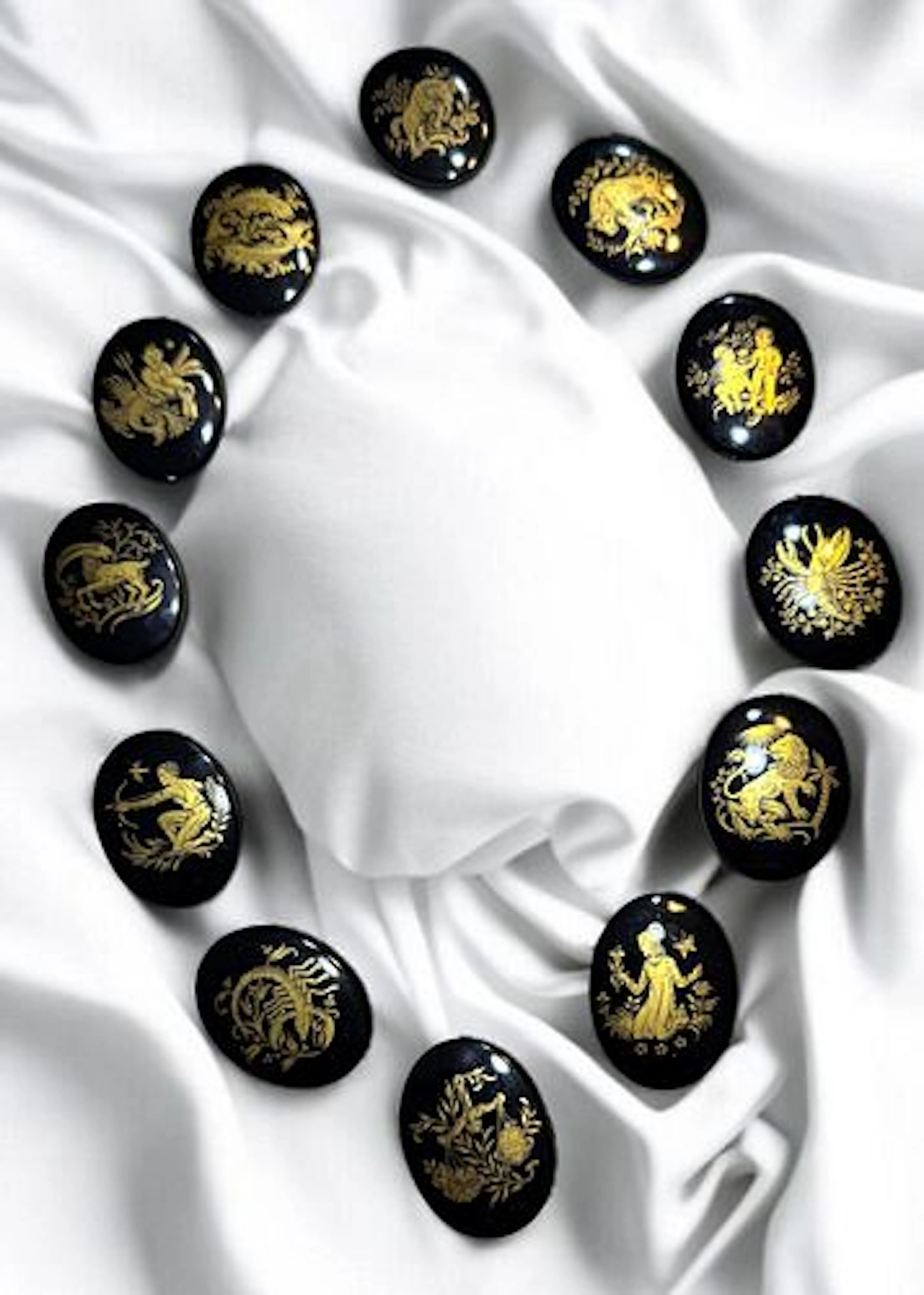 A DIVISION THREE SET OF ZODIAC BUTTONS'
