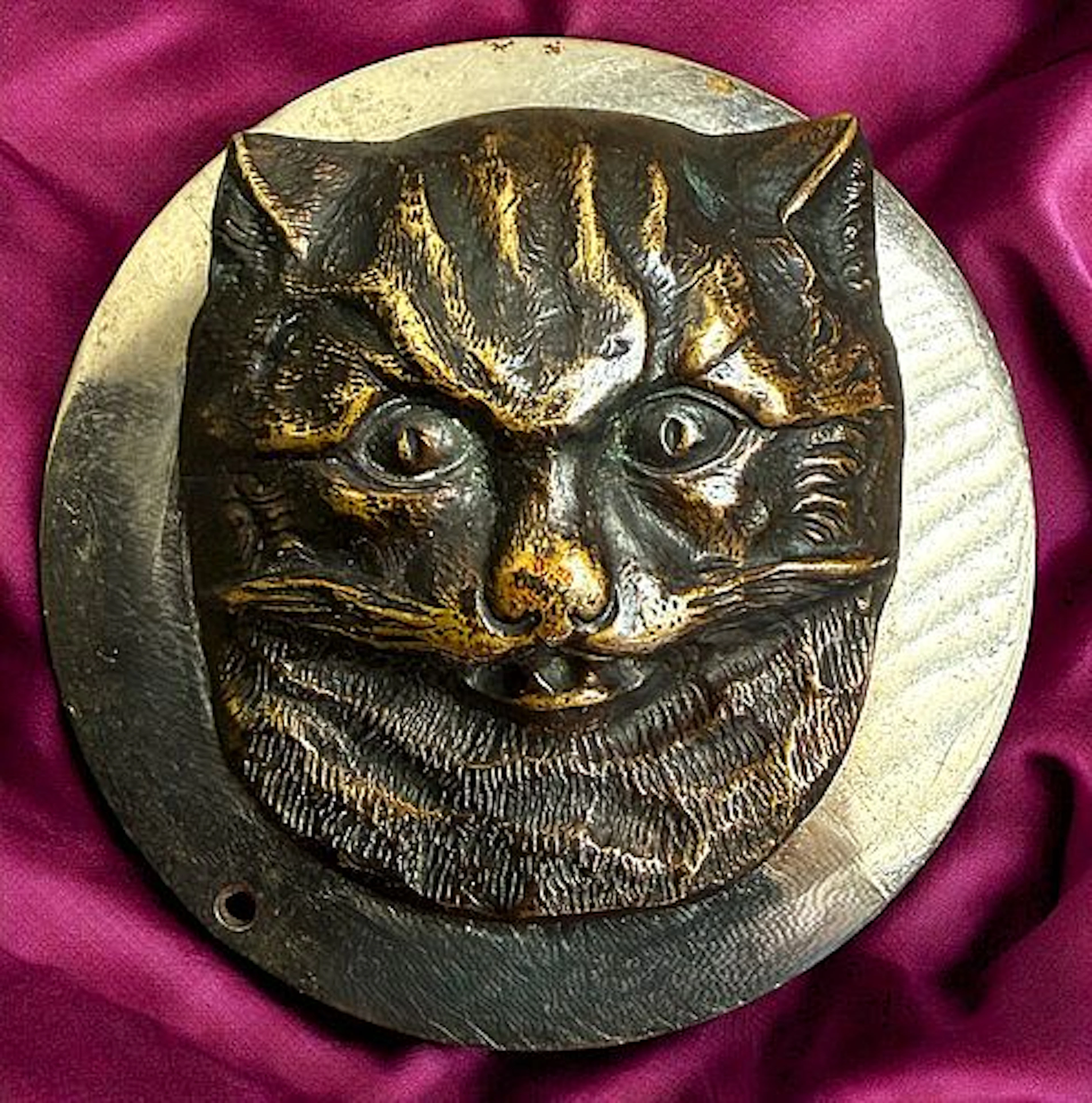 A DIVISION ONE HIGH RELIEF CAT HEAD BUTTON