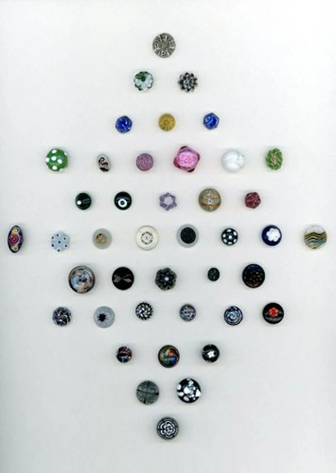 A CARD OF DIVISION ONE CHARMSTRING GLASS BUTTONS