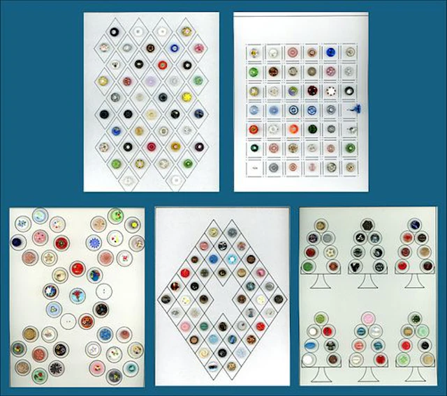 A BOX LOT INCLUDING AN ASSORTMENT OF CARDED BUTTONS