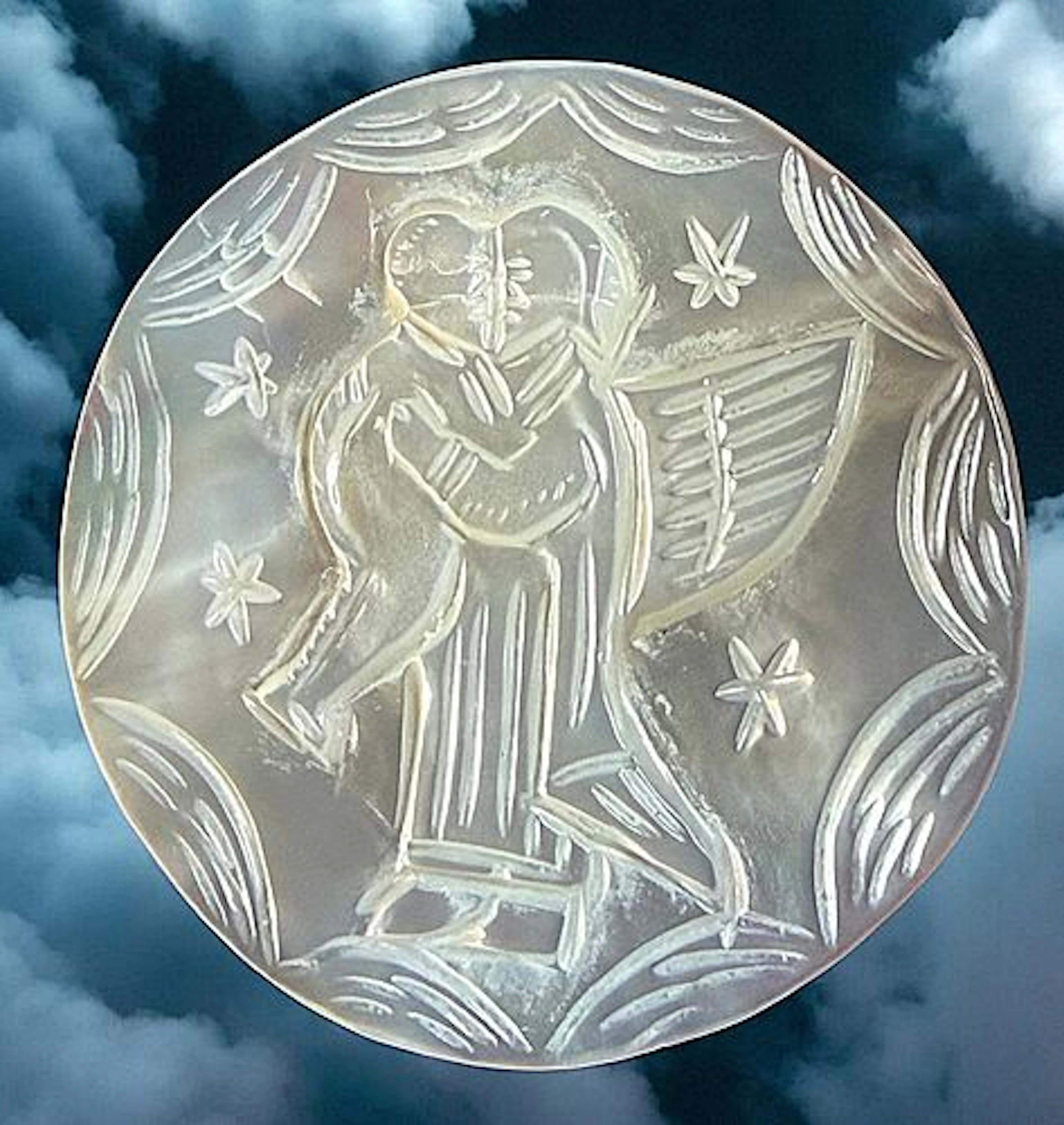 A DIVISION THREE CARVED PEARL PICTORIAL BUTTON