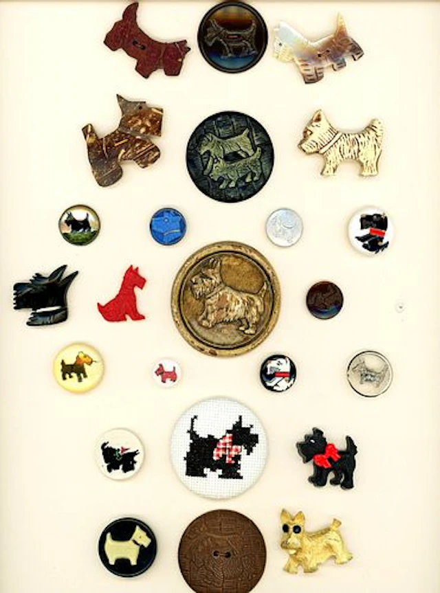 A CARD OF DIVISION THREE ASSORTED MATERIAL BUTTONS