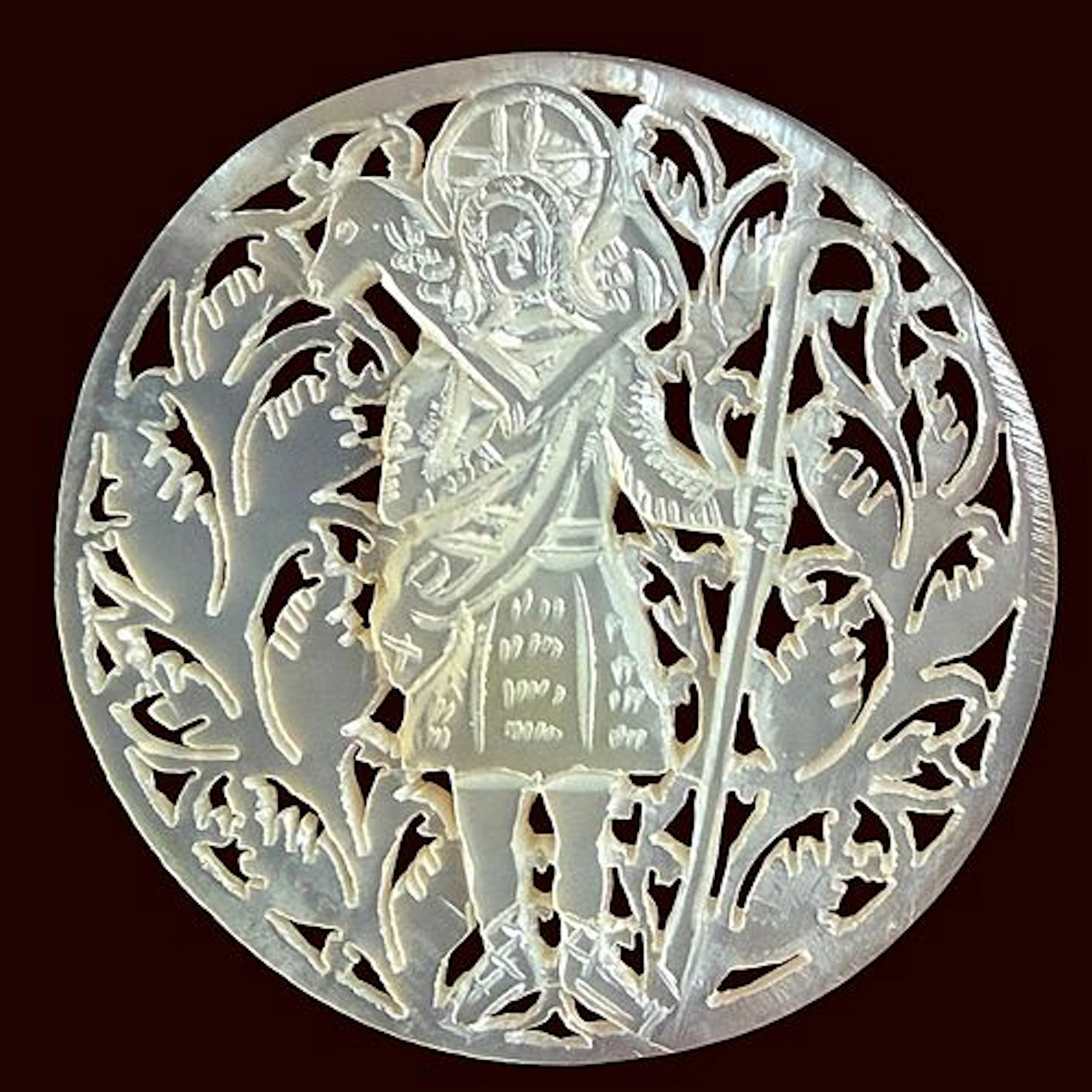 A DIVISION THREE CARVED PEARL PICTORIAL BUTTON