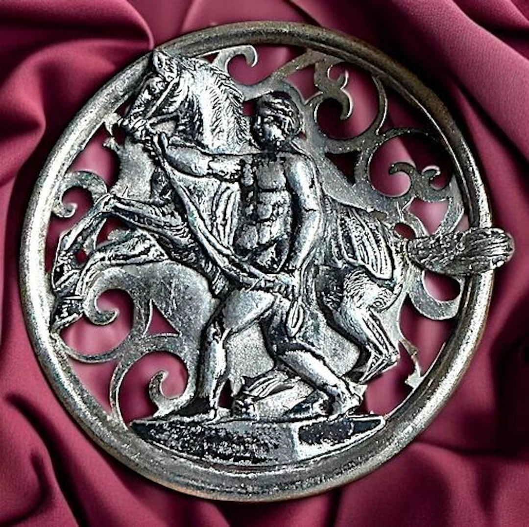 A DIVISION ONE PIERCED HORSE AND RIDER BUTTON