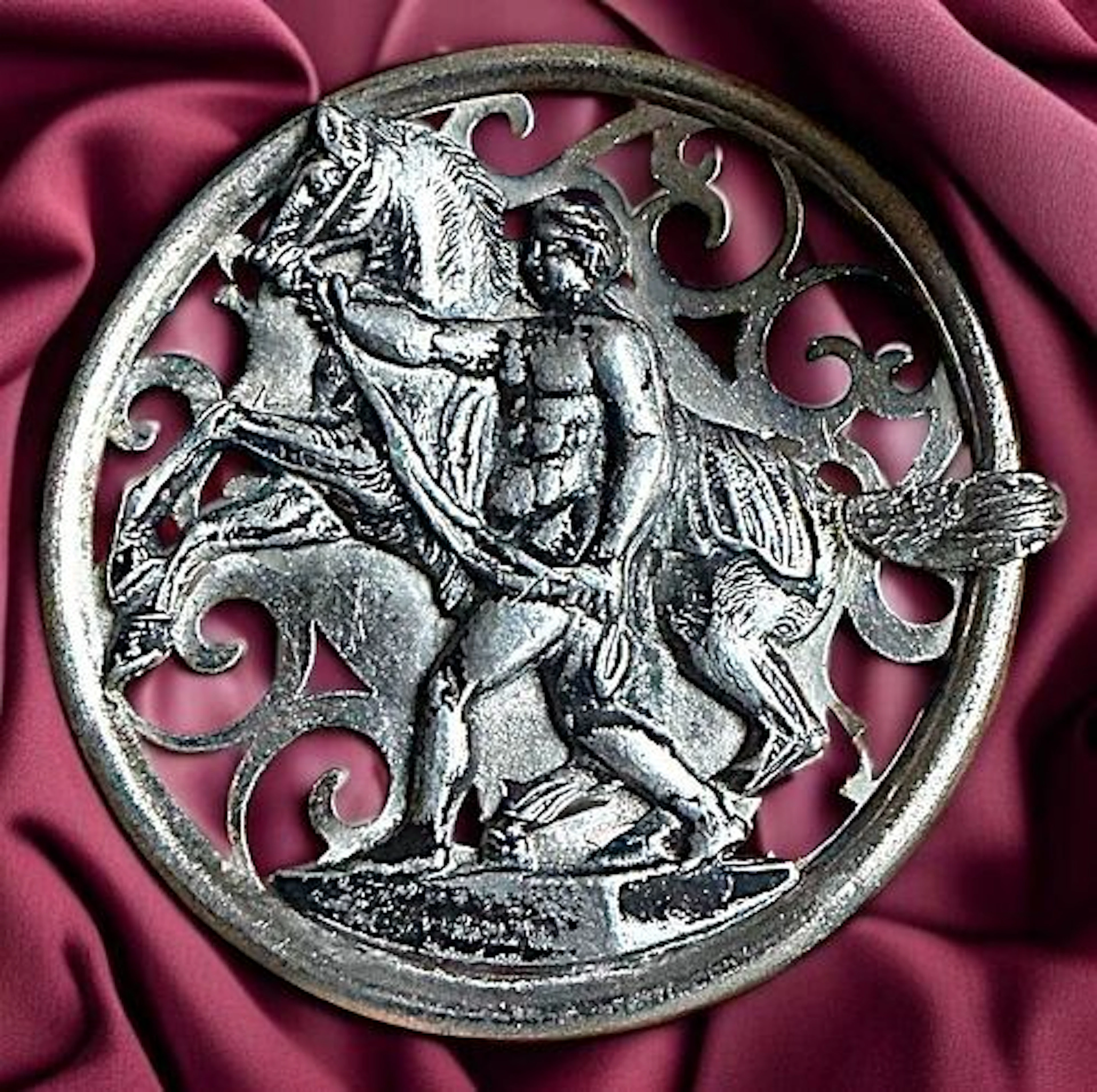 A DIVISION ONE PIERCED HORSE AND RIDER BUTTON