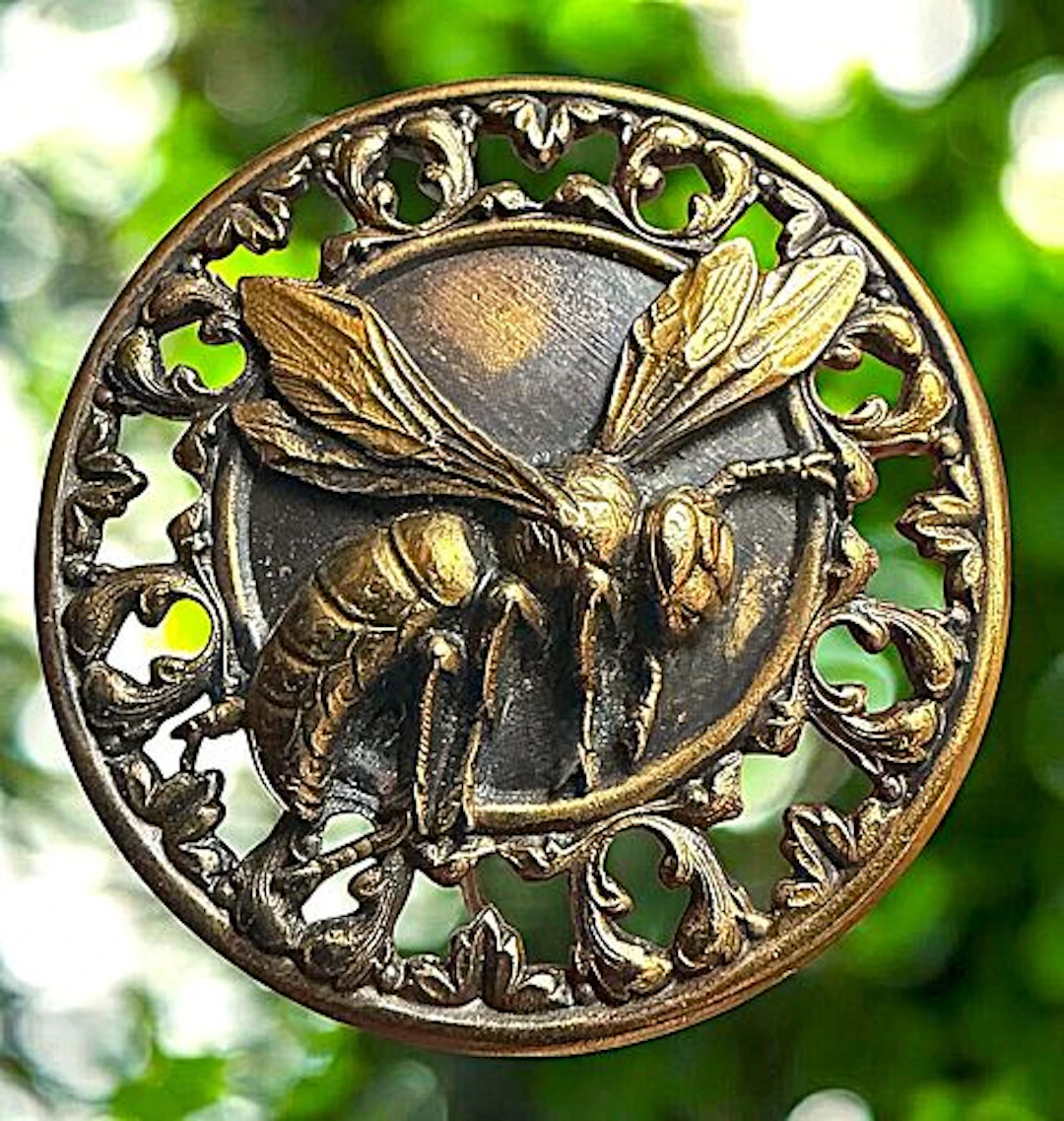A COOL DIVISION ONE PIERCED BRASS ANIMAL BUTTON
