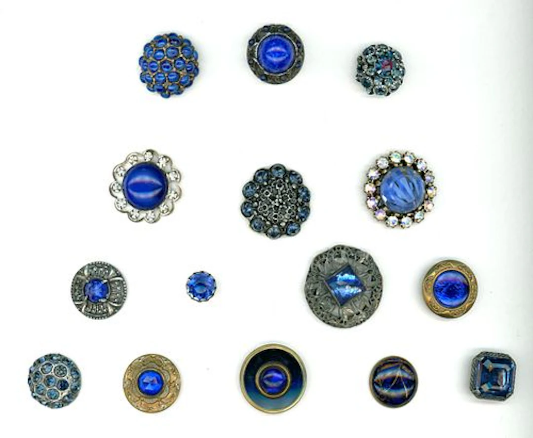 A CARD OF DIVISION ONE AND THREE JEWELED BUTTONS
