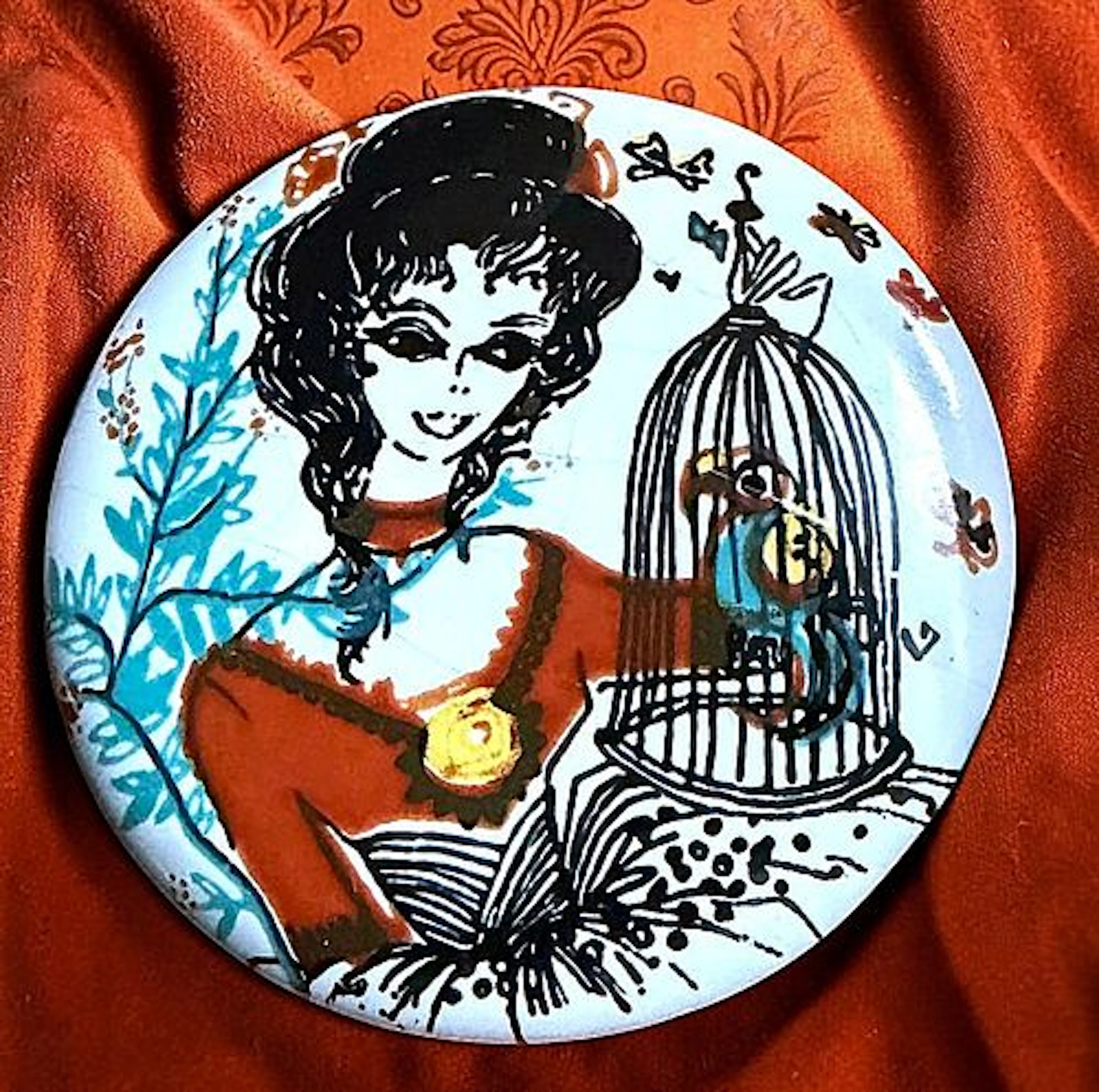 A DIVISION THREE PICTORIAL BUTTON WITH A BIRD CAGE