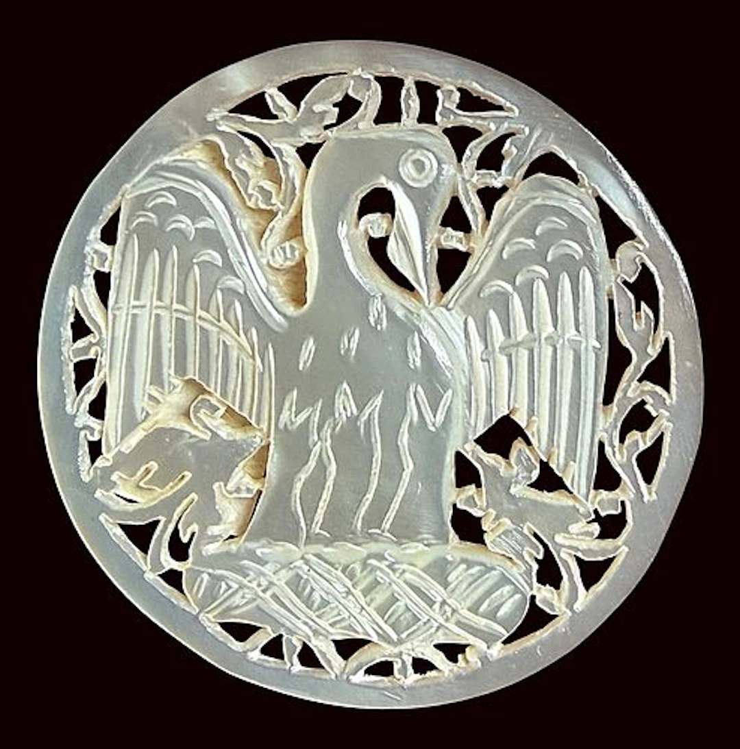 A DIVISION THREE CARVED PEARL PICTORIAL BUTTON