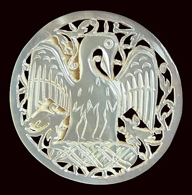 A DIVISION THREE CARVED PEARL PICTORIAL BUTTON