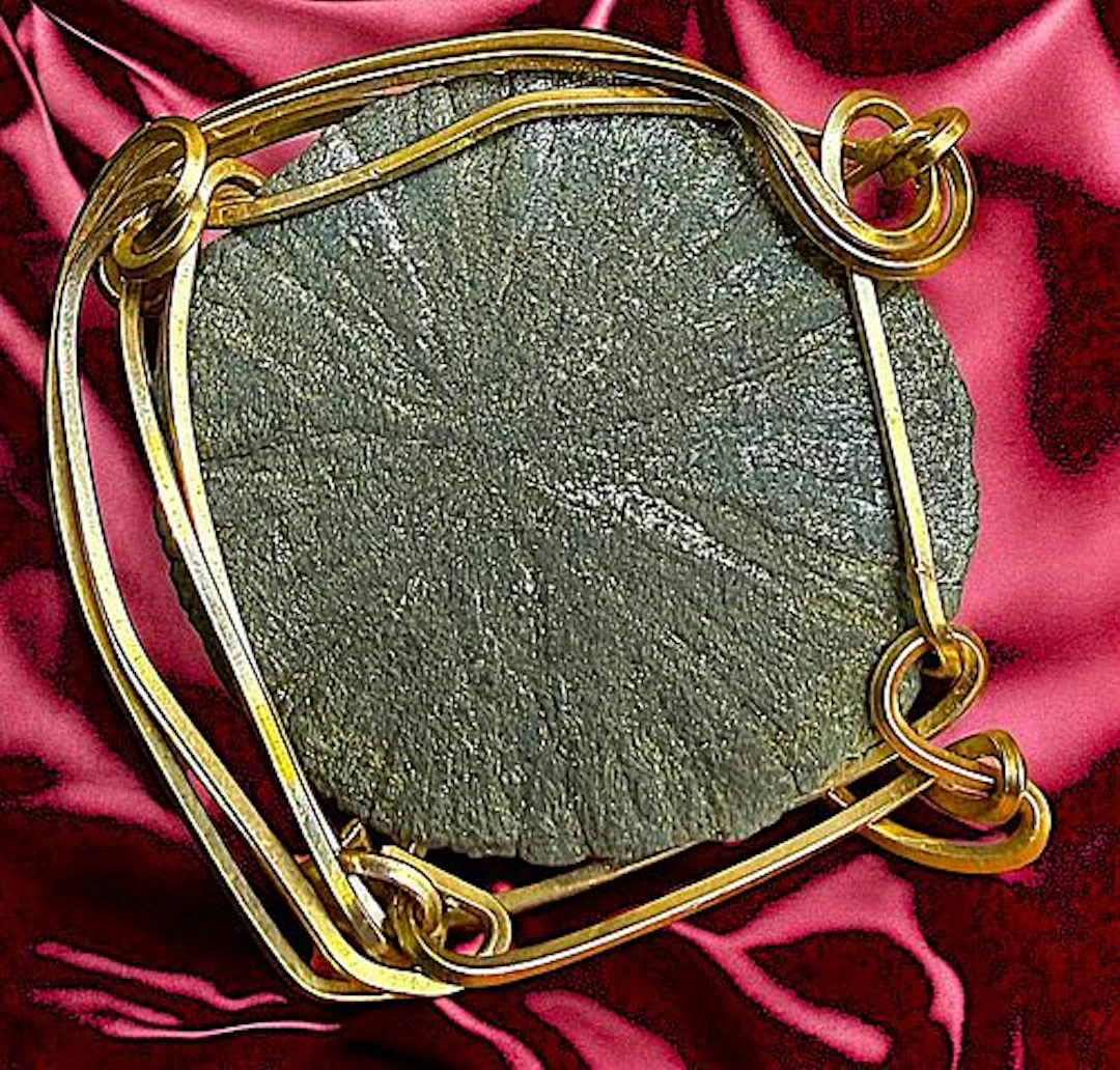 A DIVISION THREE GEMSTONE SET IN GOLD