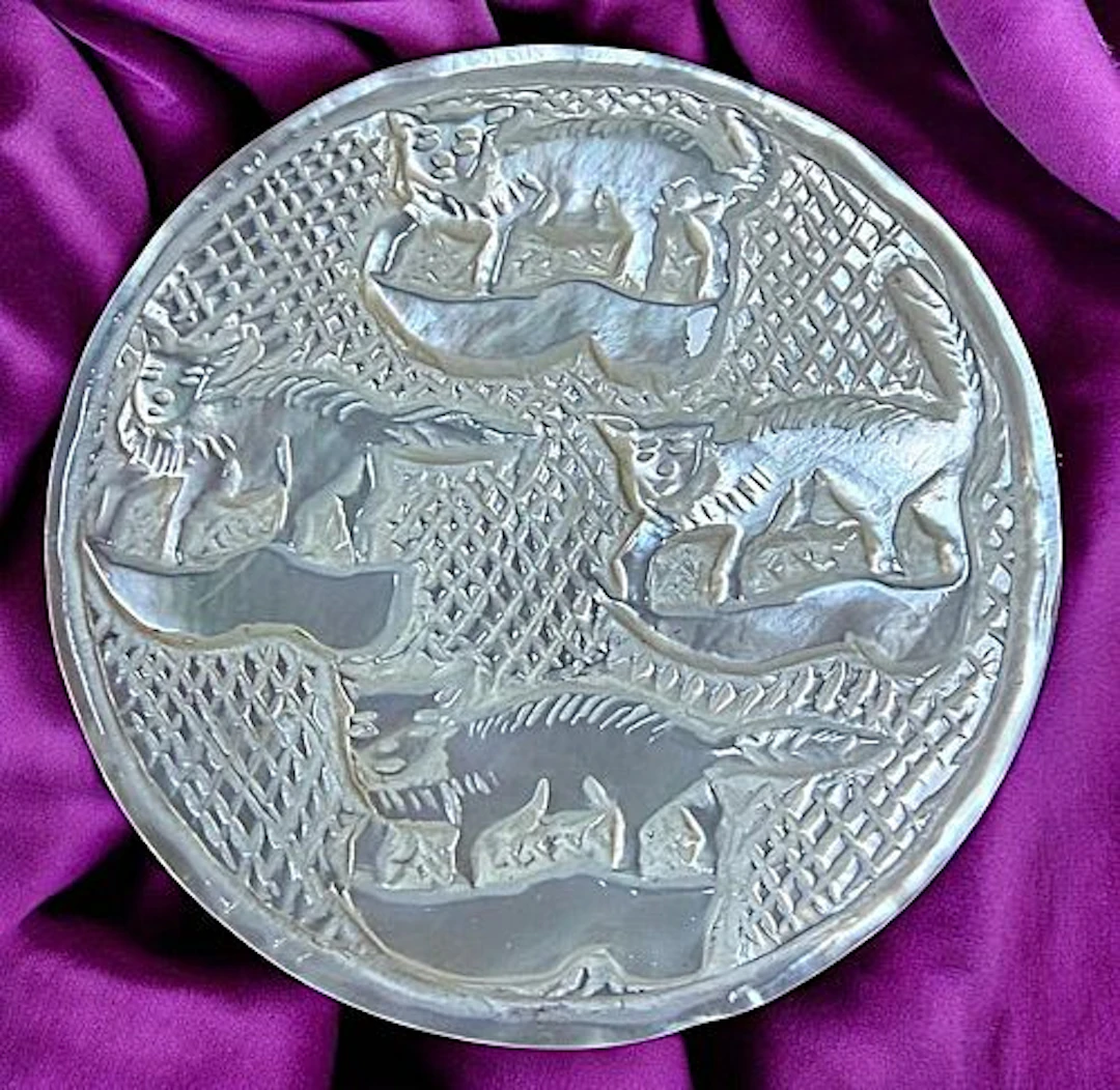 A DIVISION THREE CARVED PEARL ANIMAL BUTTON