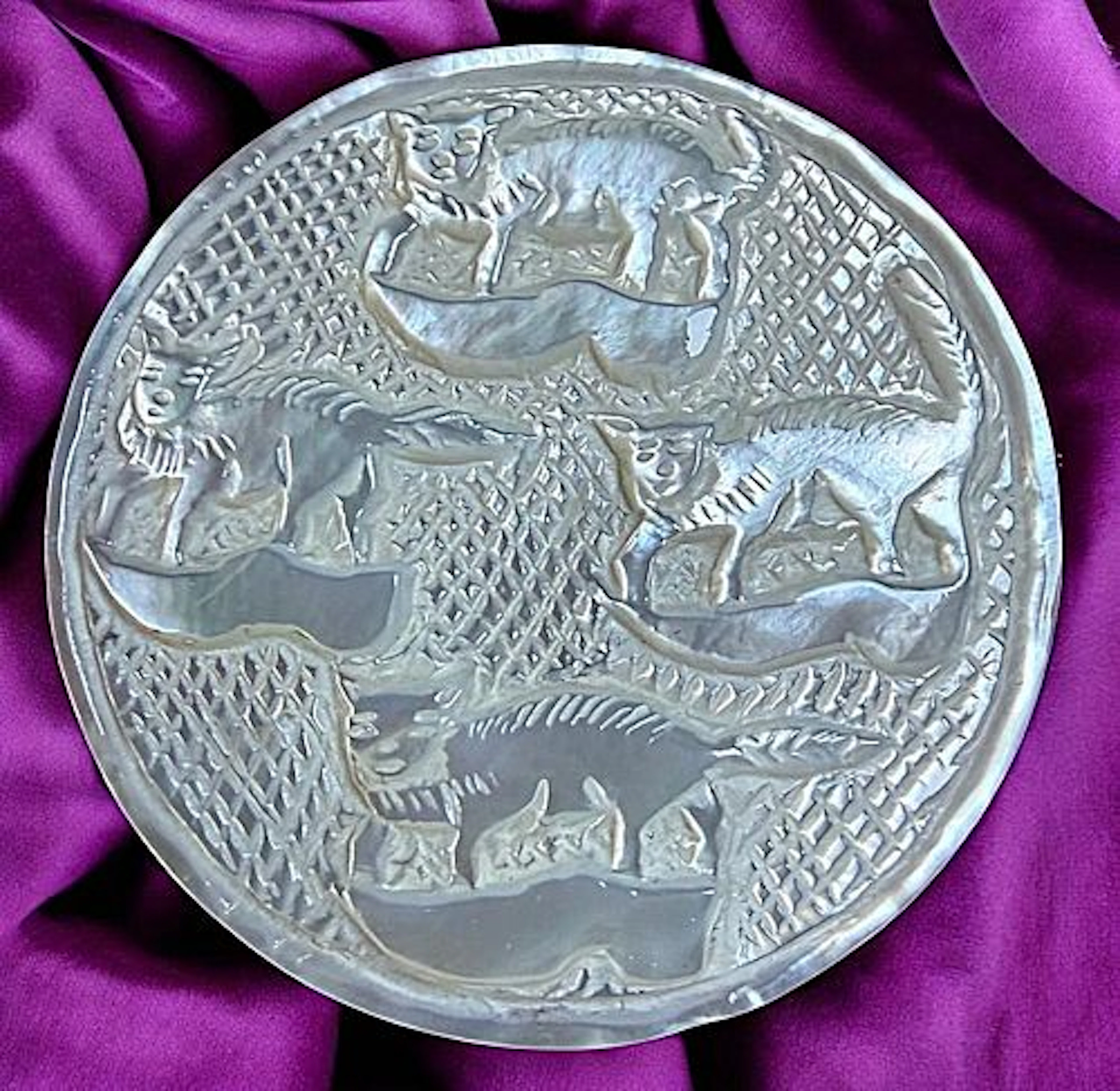 A DIVISION THREE CARVED PEARL ANIMAL BUTTON