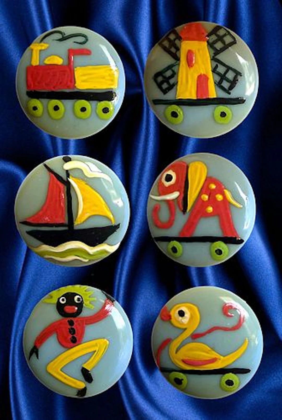 A SET OF DIV. 3 HAND PAINTED CASEIN PICTORIAL BUTTONS