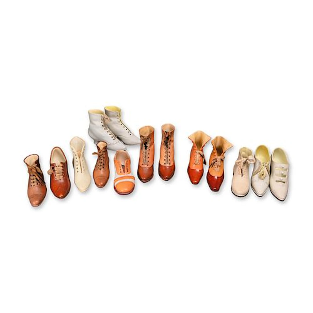 A Collection of Bisque and Glazed Porcelain Miniature Footwear